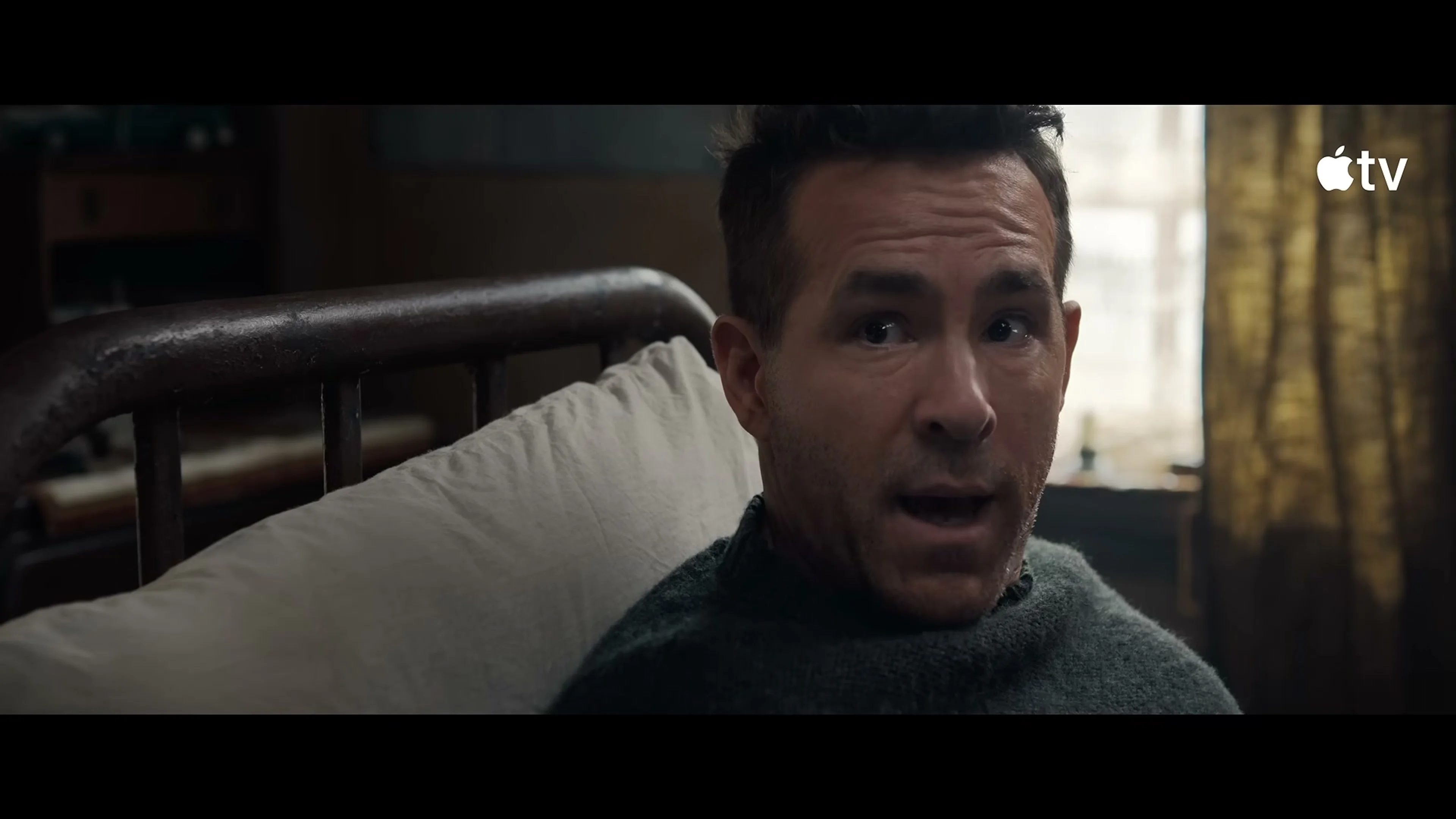 Ryan Reynolds as Troy Kelly wakes in Nikolai's cabin in Mayday.