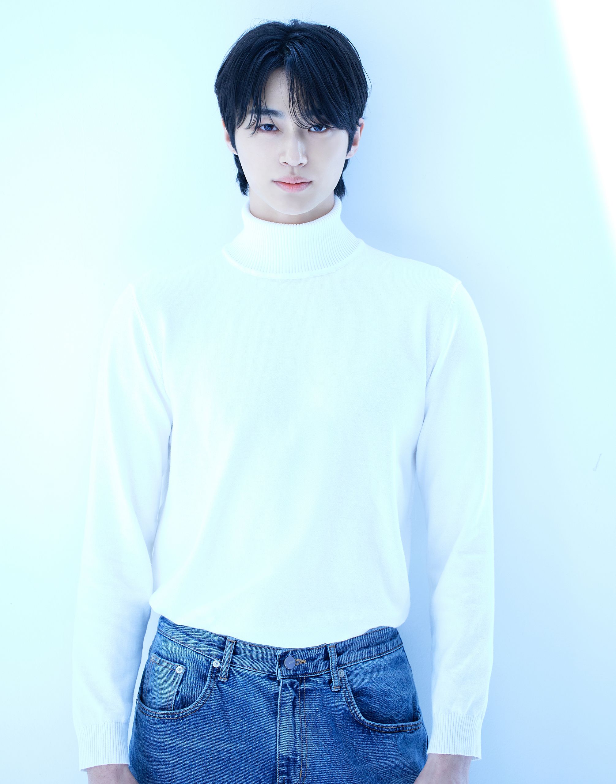 Byeon Woo-seok wearing a white sweater in an official VARO Entertainment portrait.
