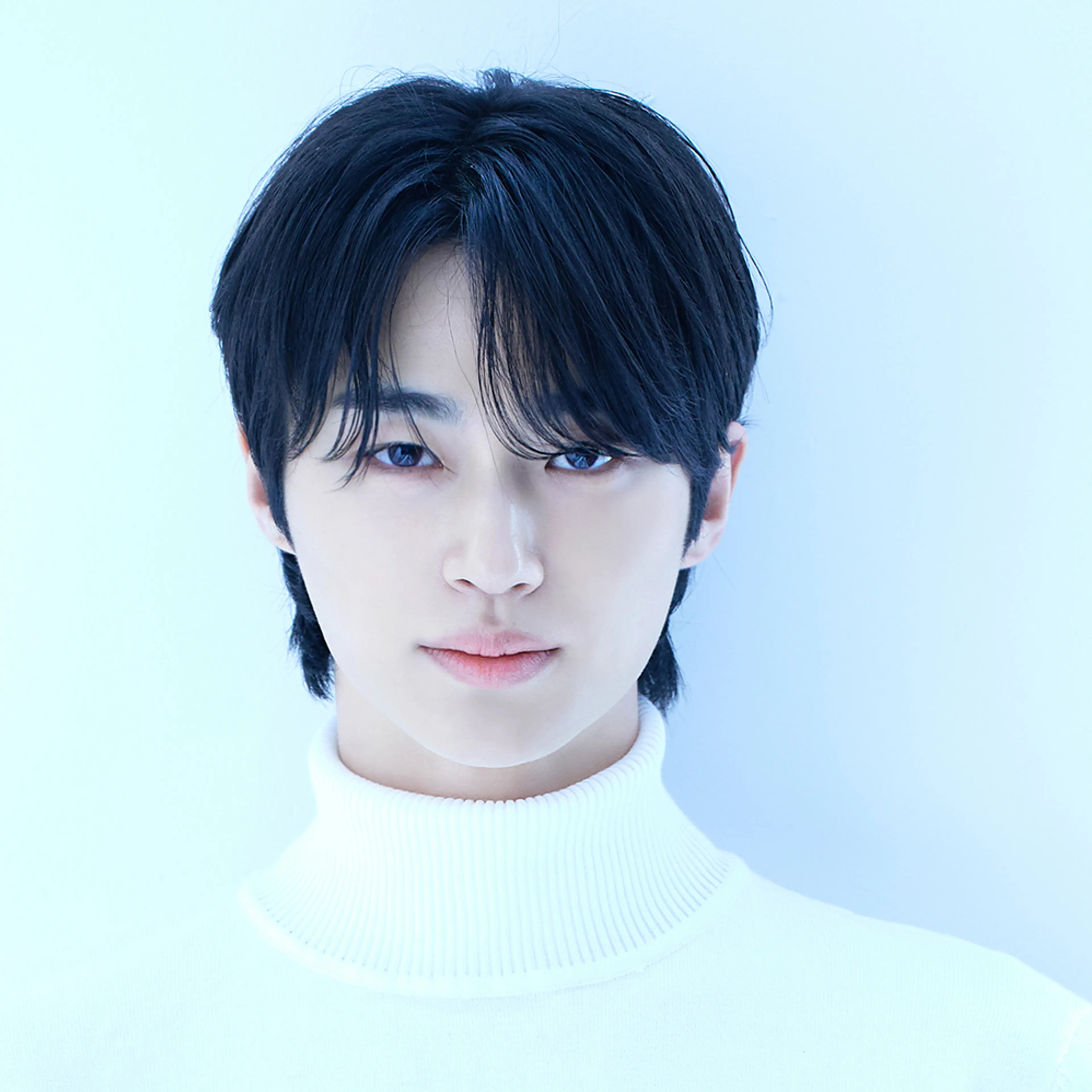 Byeon Woo-seok wearing a white sweater in an official VARO Entertainment portrait.