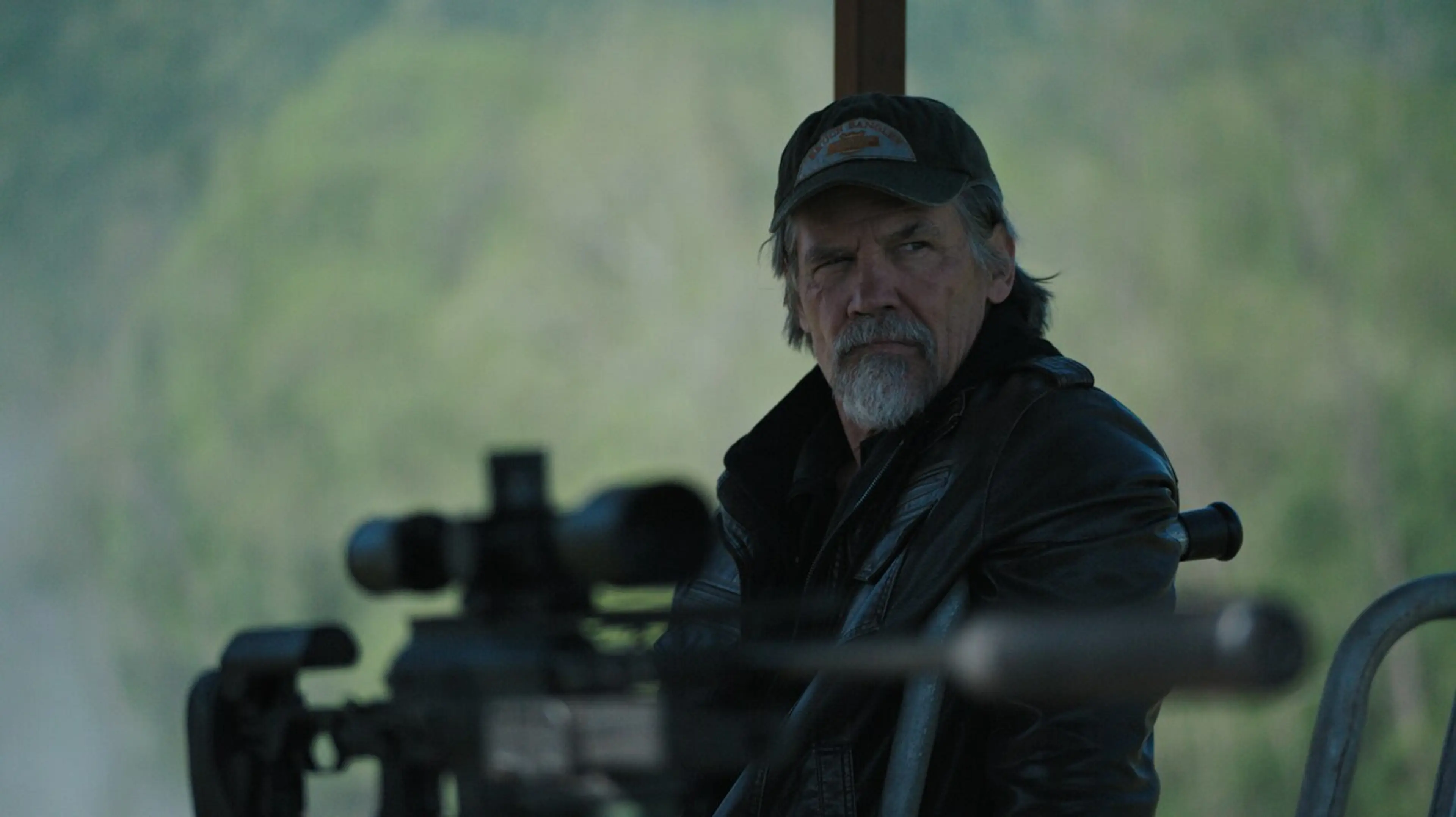 Josh Brolin as Bangley sits behind a scoped rifle in The Dog Stars.