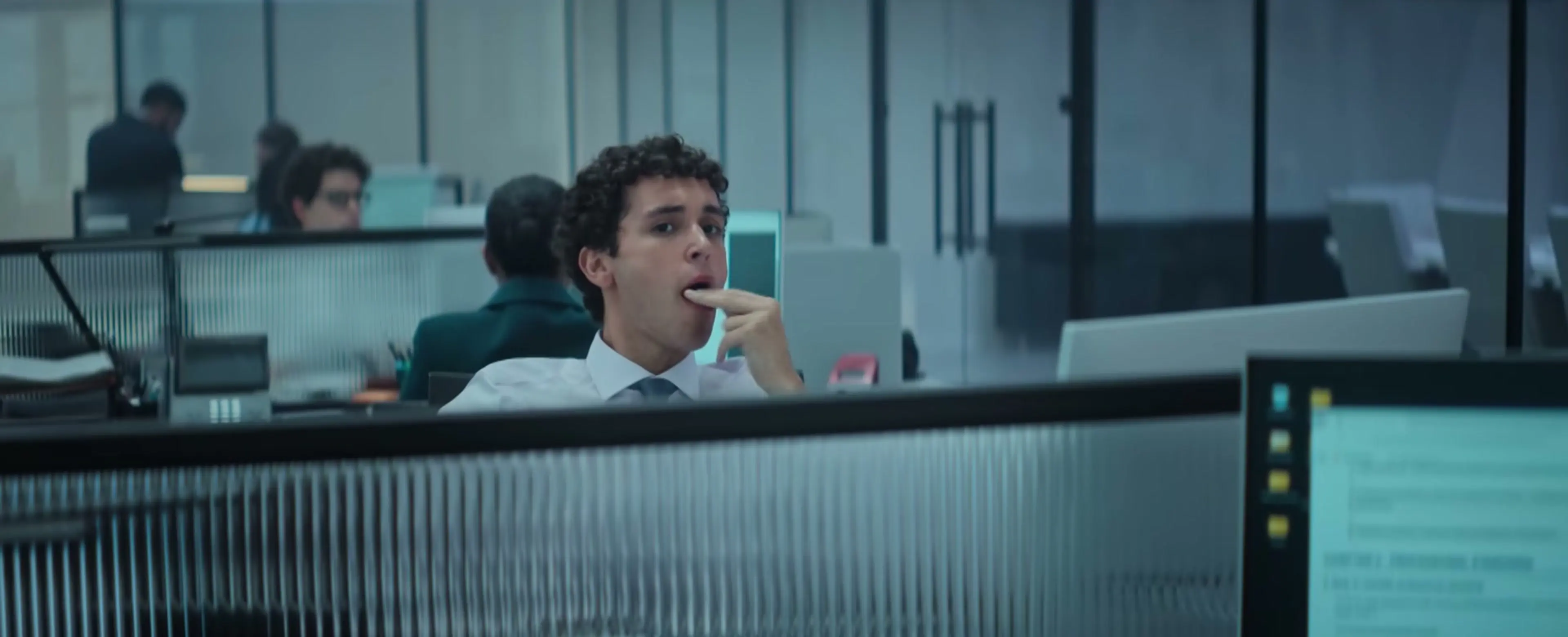 A young lawyer stands inside a modern office in WAR.