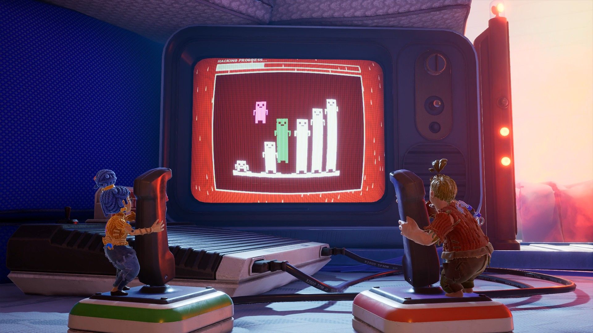 Cody and May operate two joysticks beside an old screen.