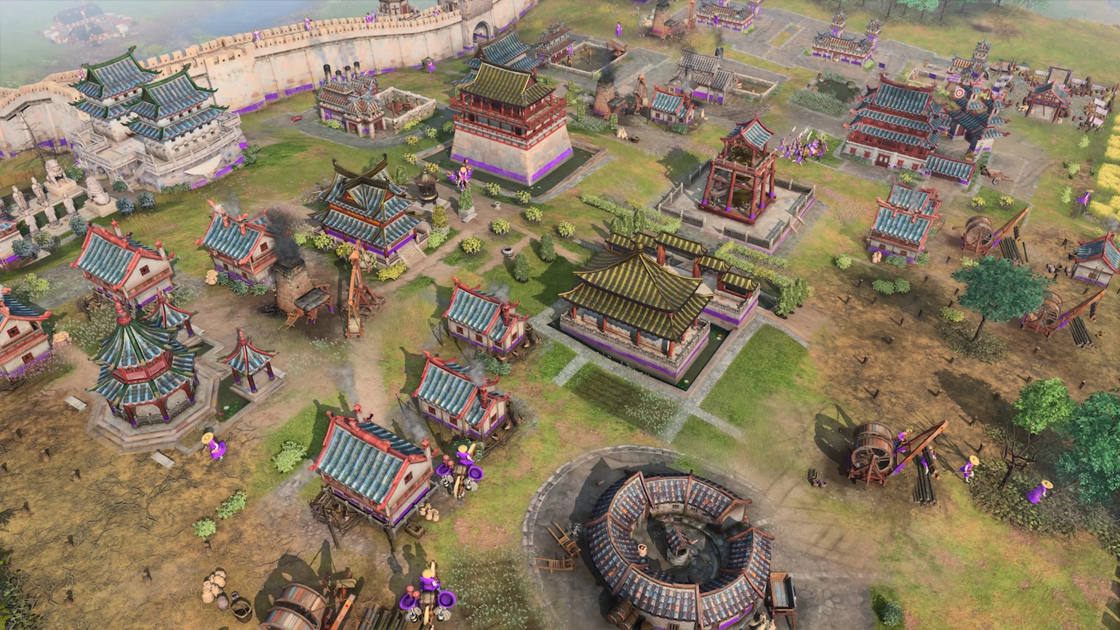 A large walled settlement in Age of Empires IV. Civilization rules shape how a base develops through the ages.