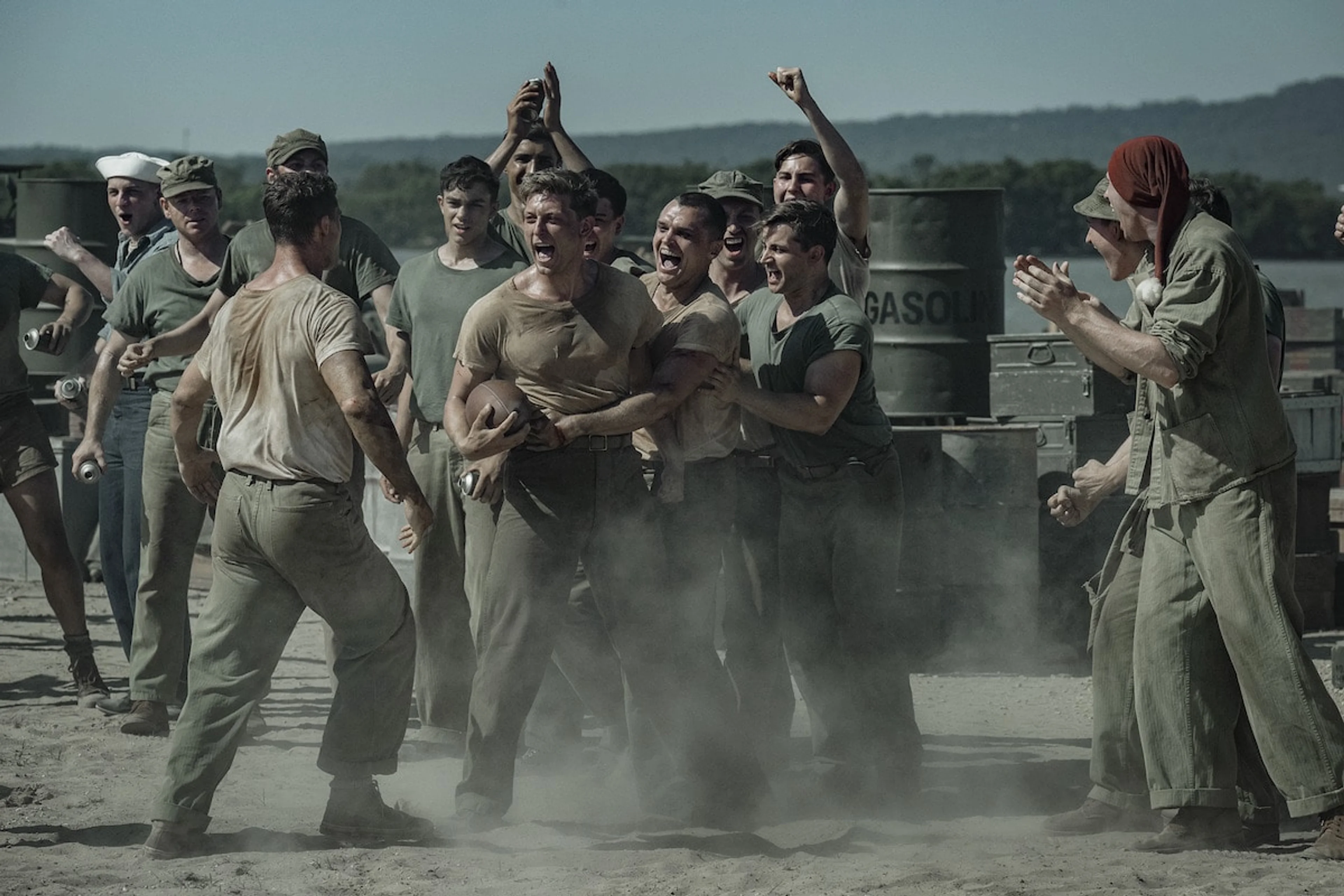 Tom Francis and other cast members train together in a wide film still.