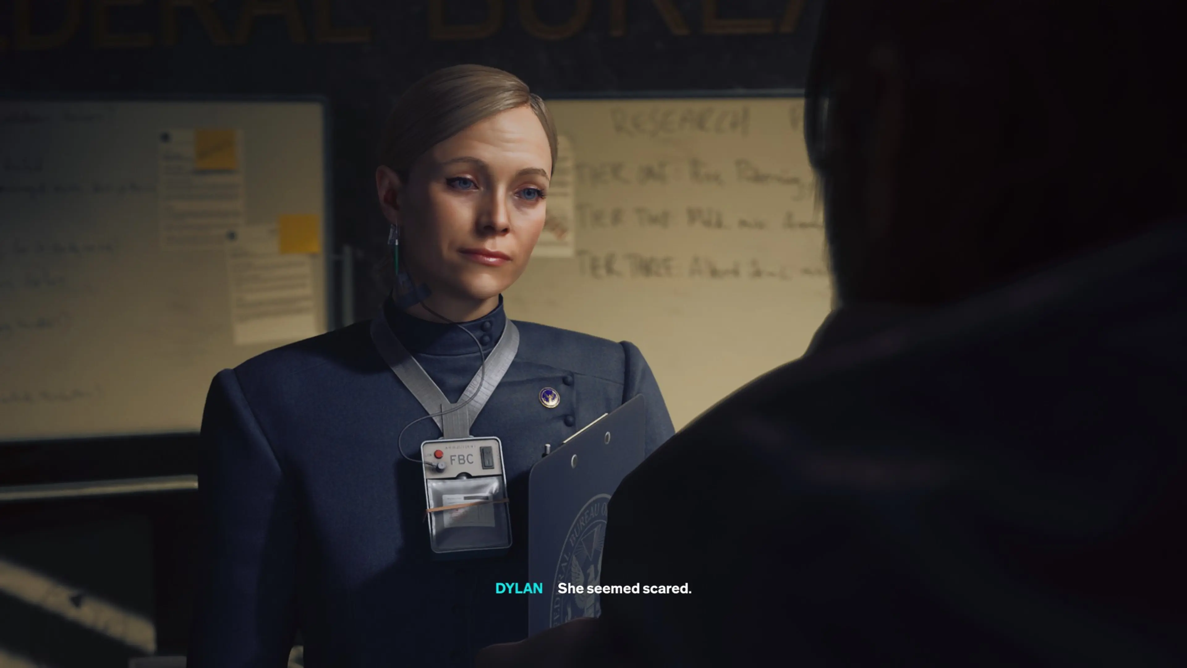 Emily Pope holds a folder while speaking with Dylan.