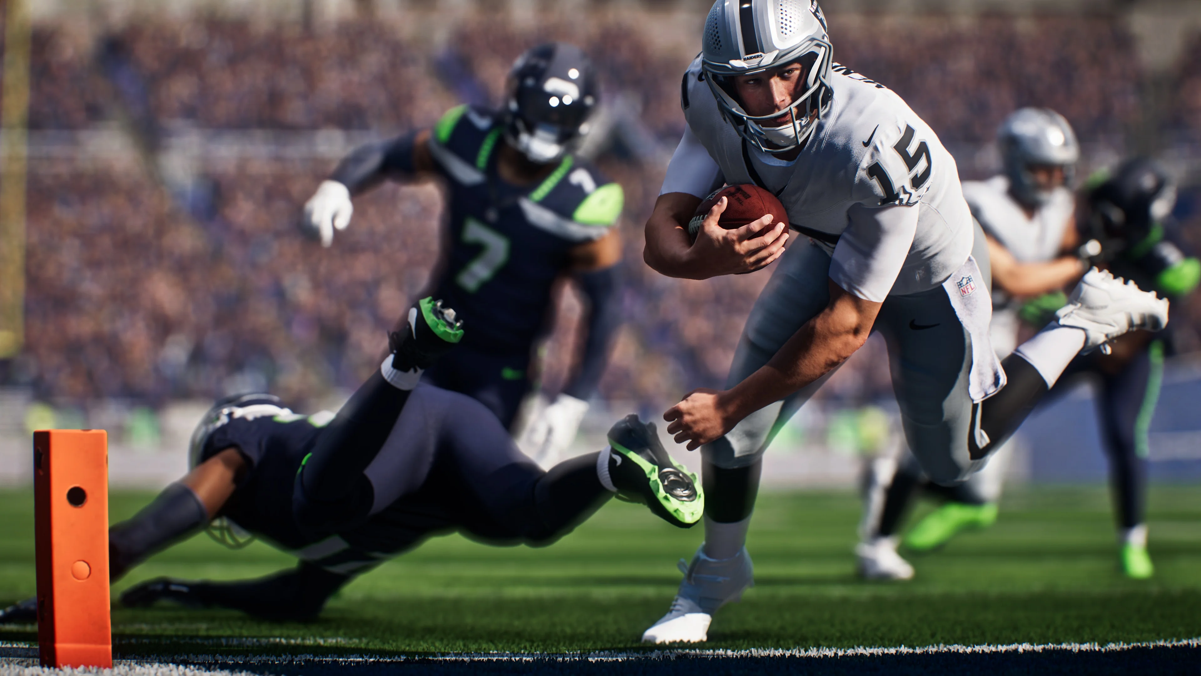 A Las Vegas Raiders ball carrier escapes a diving Seattle Seahawks defender near the goal line in Madden NFL 27.