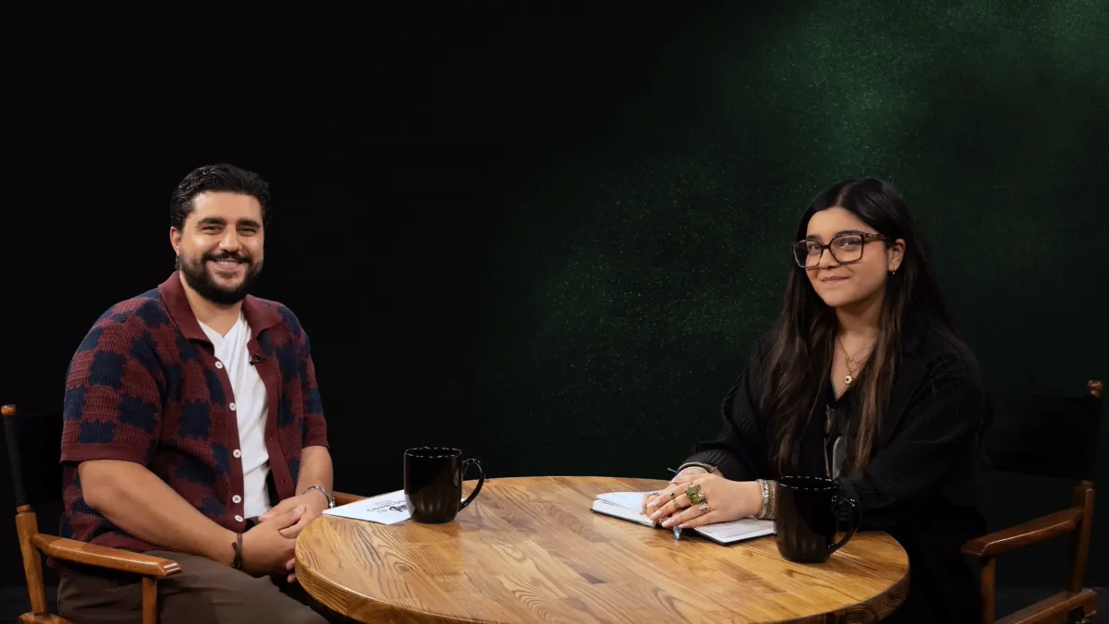 Iman Vellani and a podcast guest sit at a table in another official Countdown to Avengers: Doomsday image.