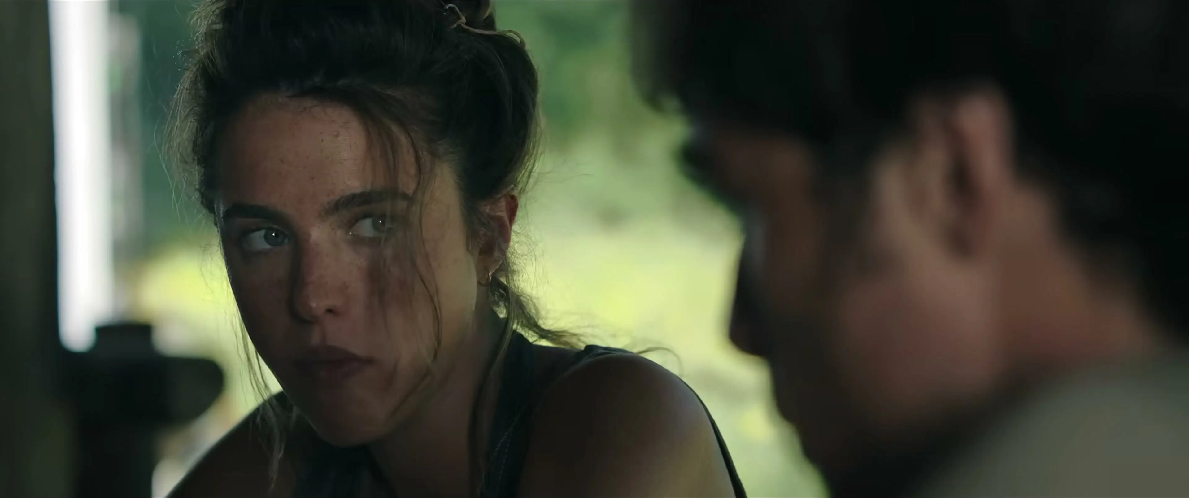 Margaret Qualley as Cima looks across a table at Hig in The Dog Stars.