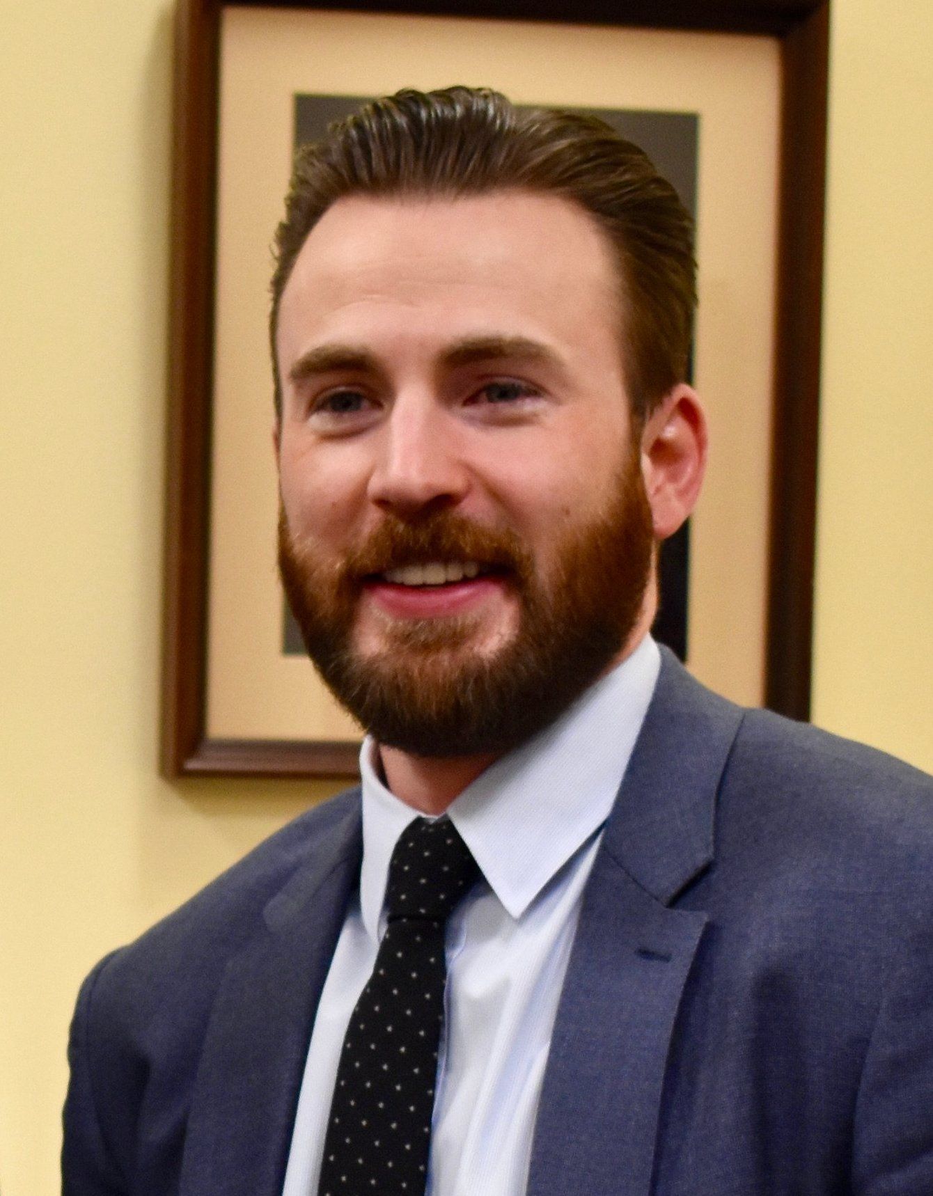 Chris Evans with a beard and navy suit during a March 2019 visit to the U.S. Capitol.