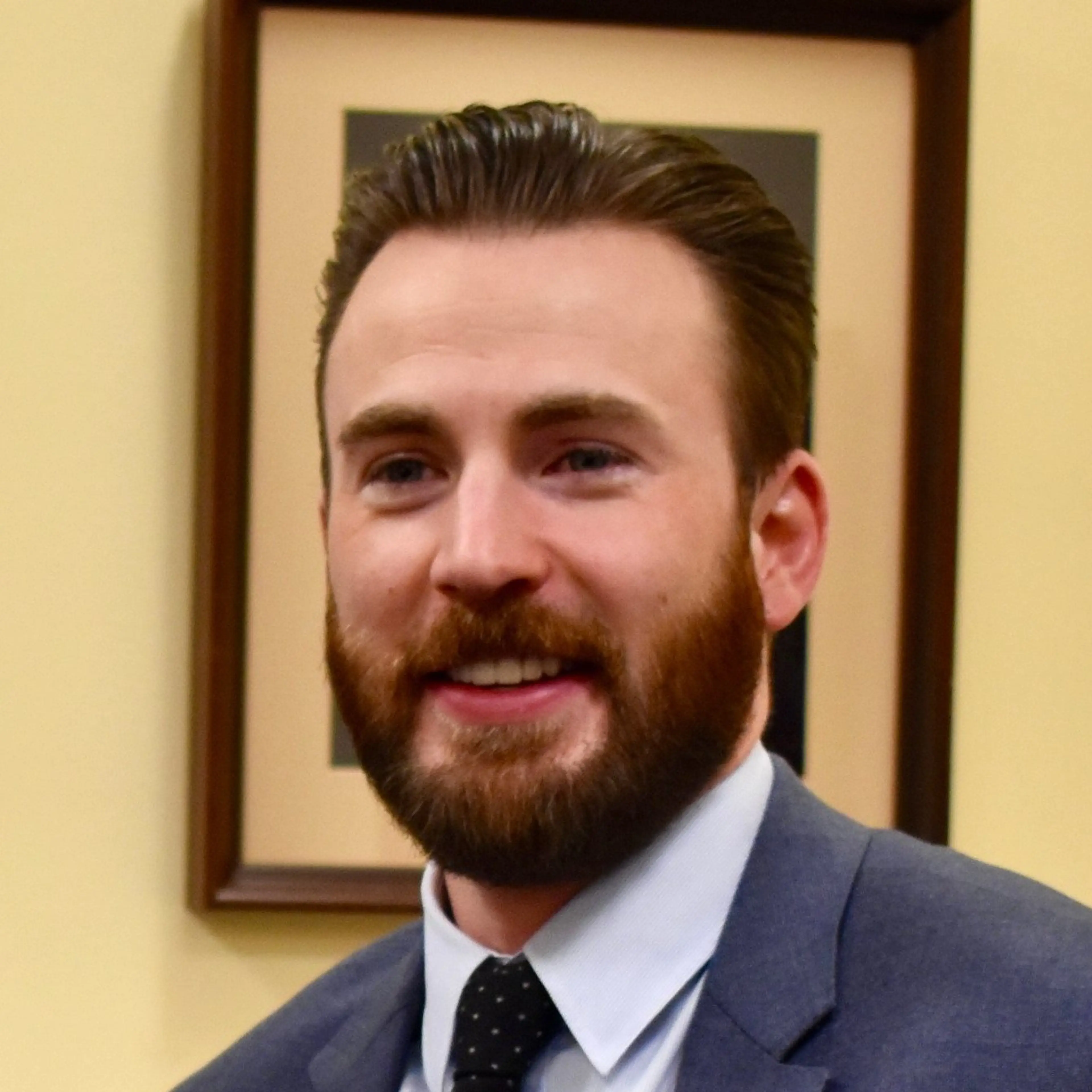 Chris Evans with a beard and navy suit during a March 2019 visit to the U.S. Capitol.