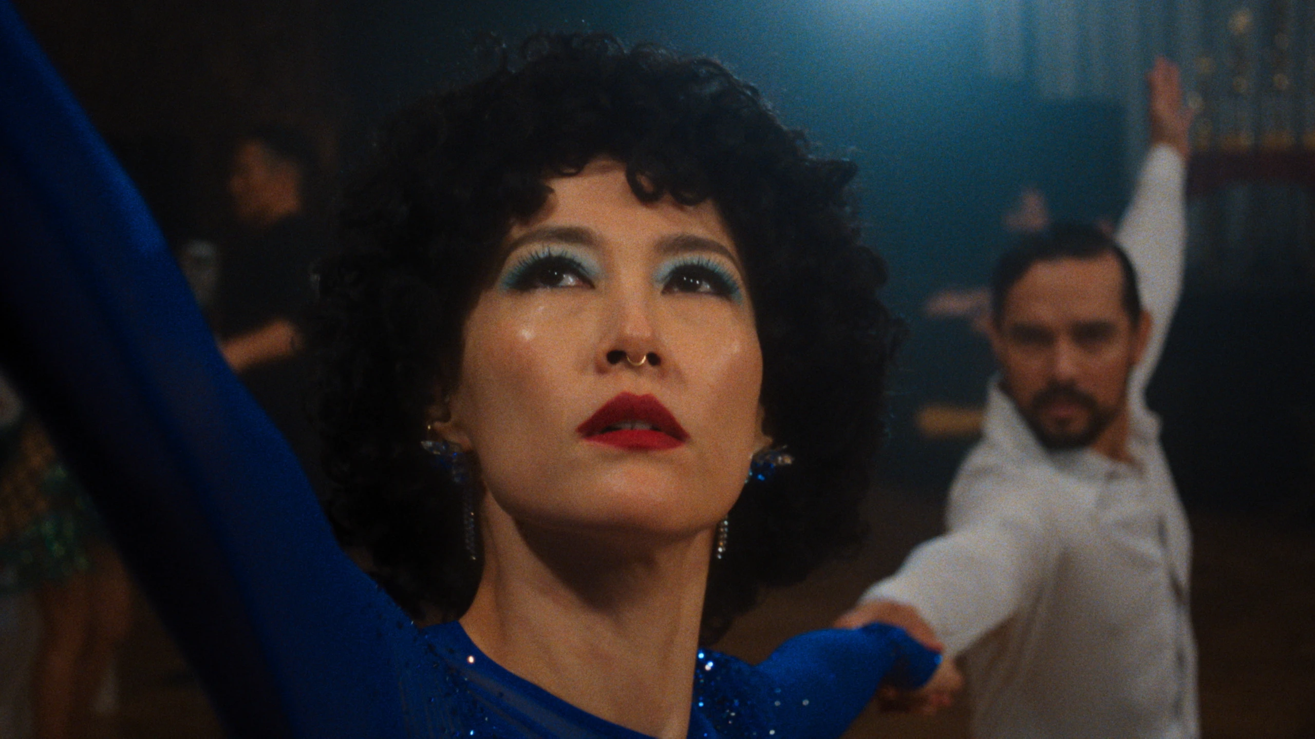 Rinko Kikuchi as Haru dancing in a blue dress in Ha-Chan, Shake Your Booty!