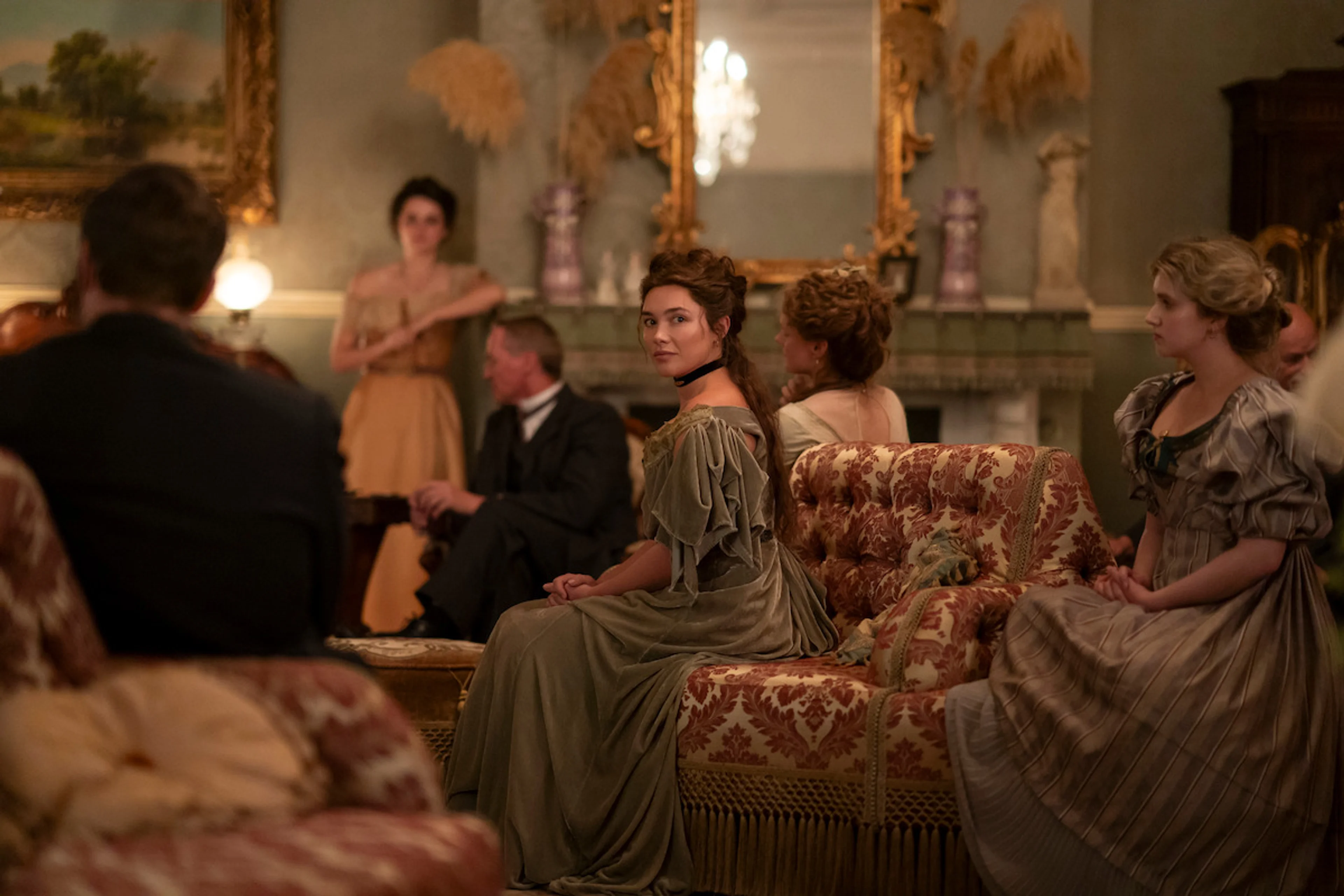 Cathy Ames sits among guests in an ornate nineteenth-century drawing room in East of Eden.
