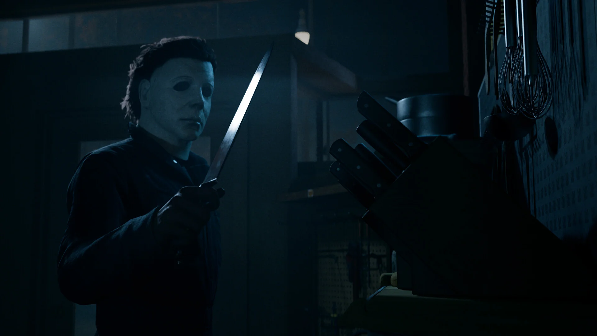 Michael Myers holds a kitchen knife beside a knife block in Halloween: The Game.