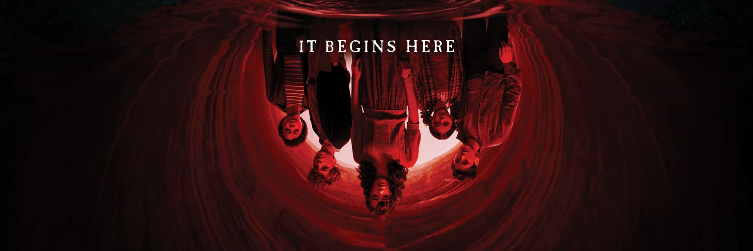 The cast of IT: Welcome to Derry hangs upside down in a red tunnel as Pennywise watches from below.