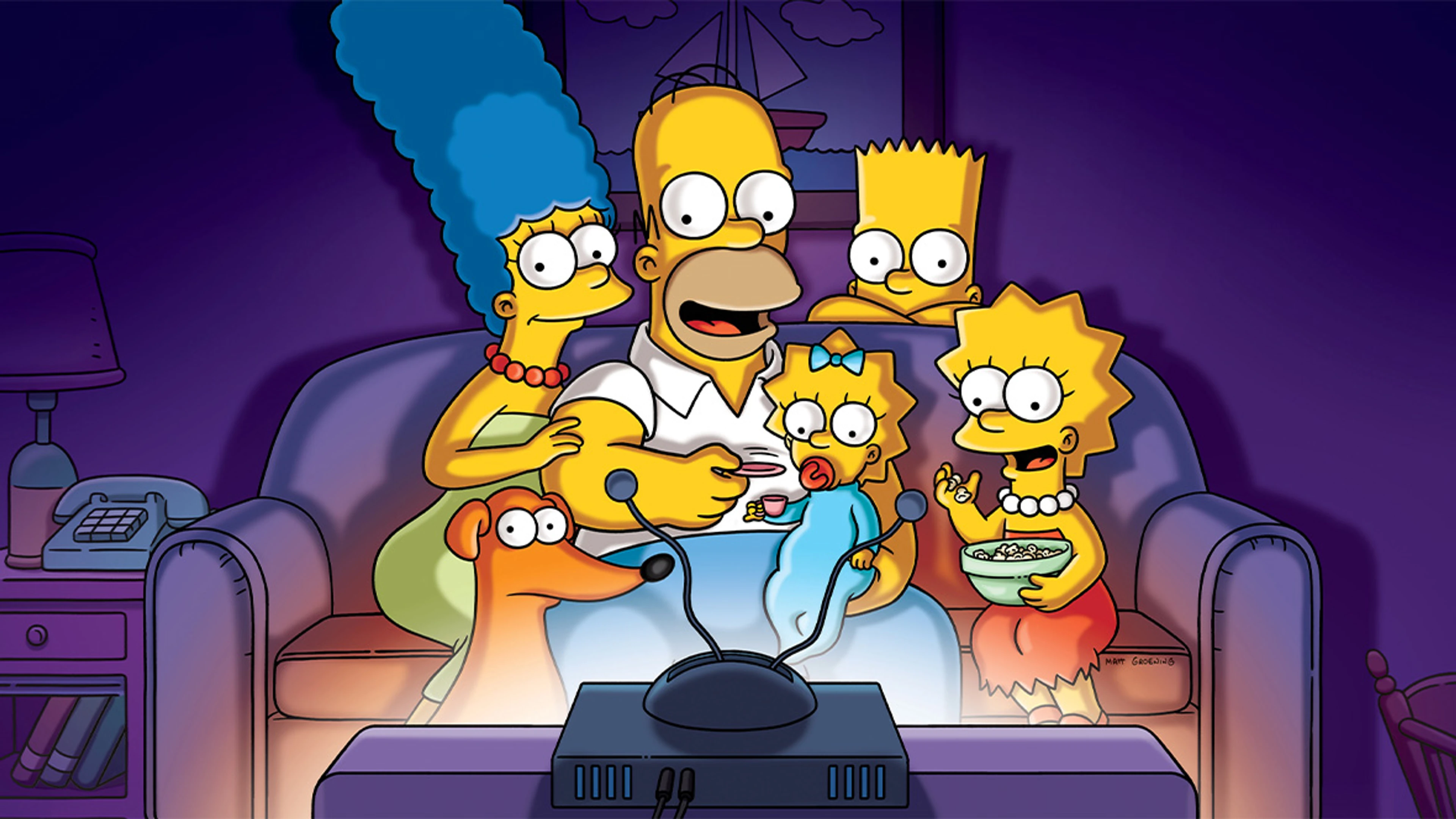Homer, Marge, Bart, Lisa, and Maggie sitting together on the couch.