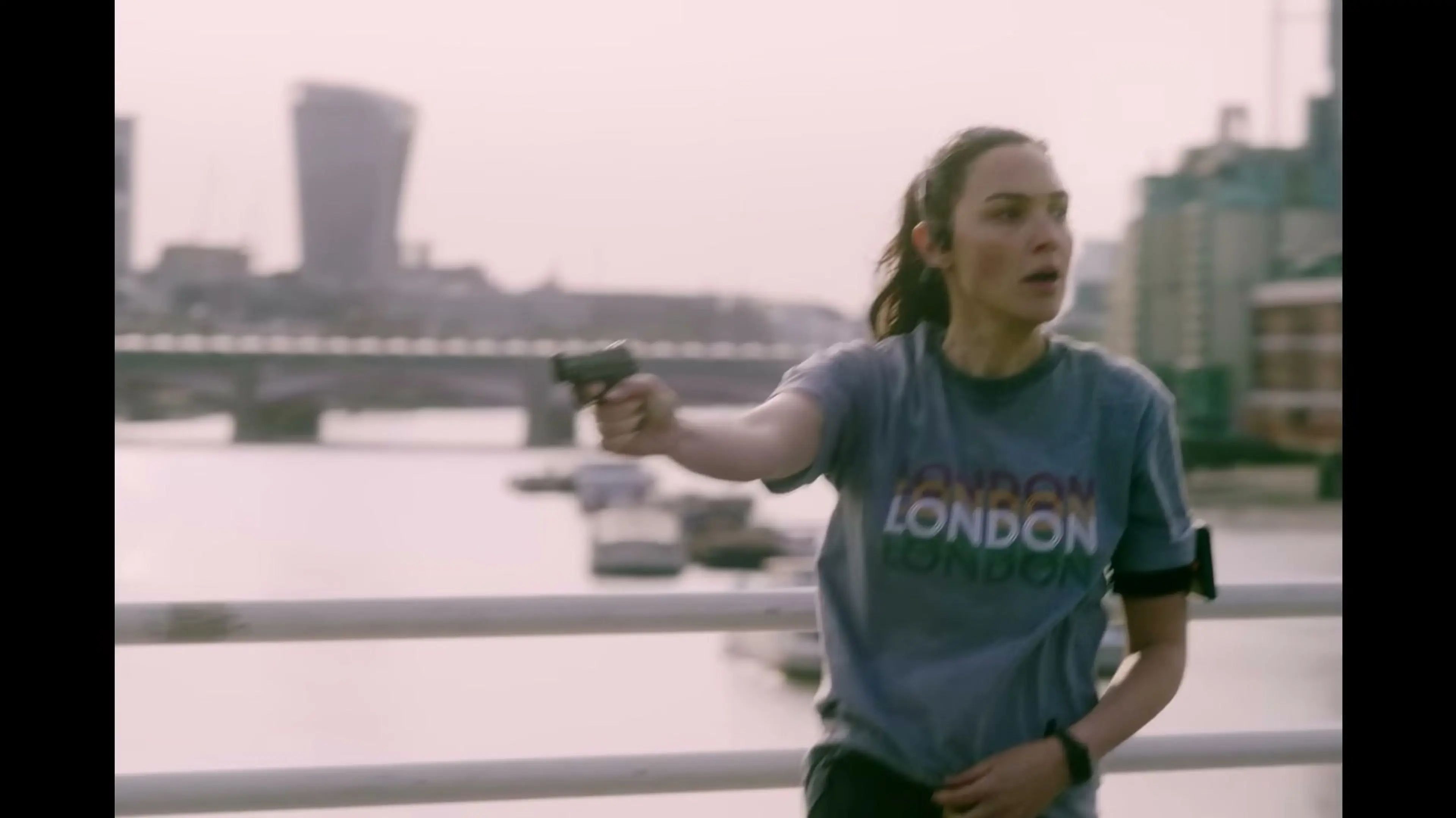Maia Marten aims a handgun during the final part of The Runner.