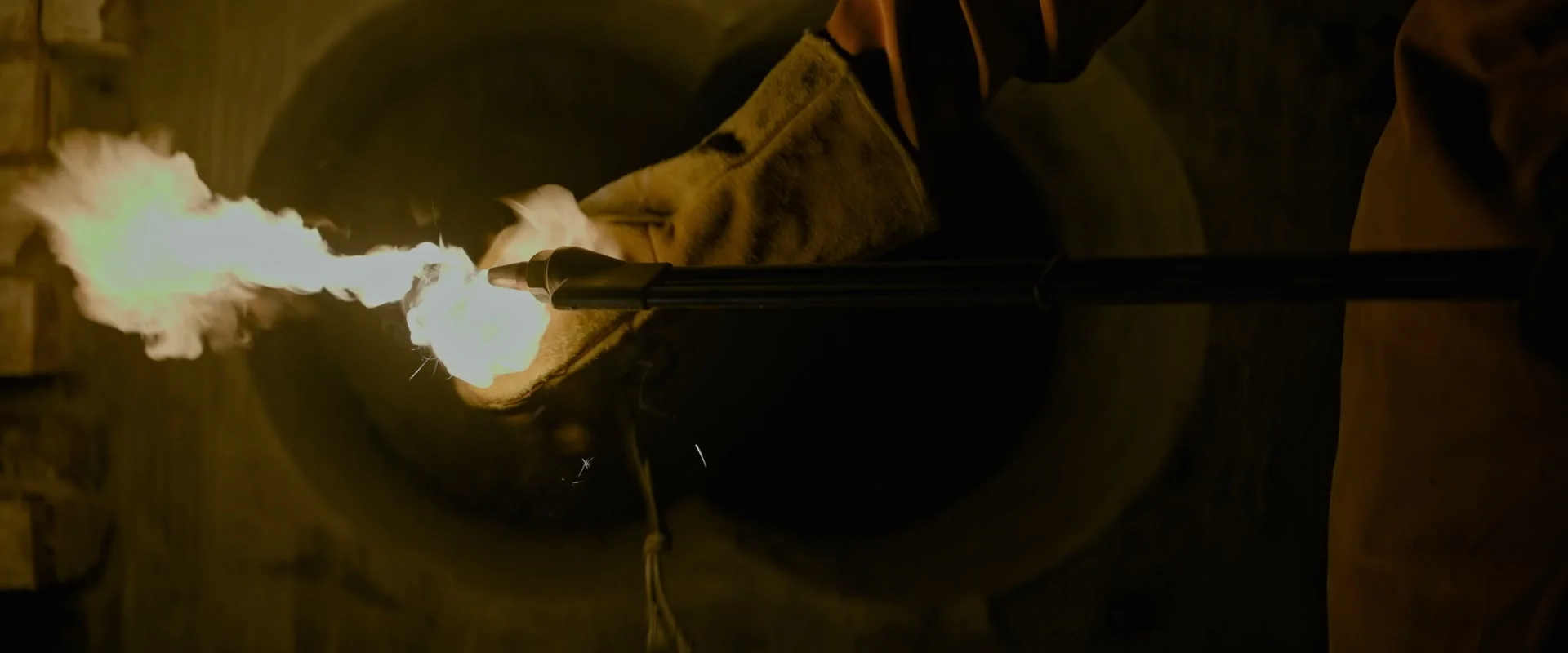 Gloved hands hold a lit cutting torch during the robbery in Fuze.