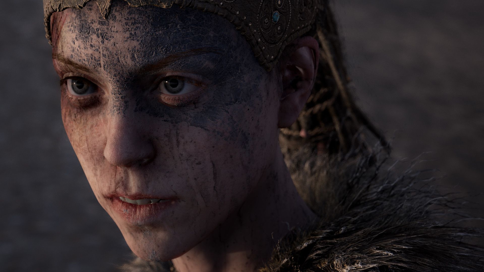 Close view of Senua’s face and painted features.