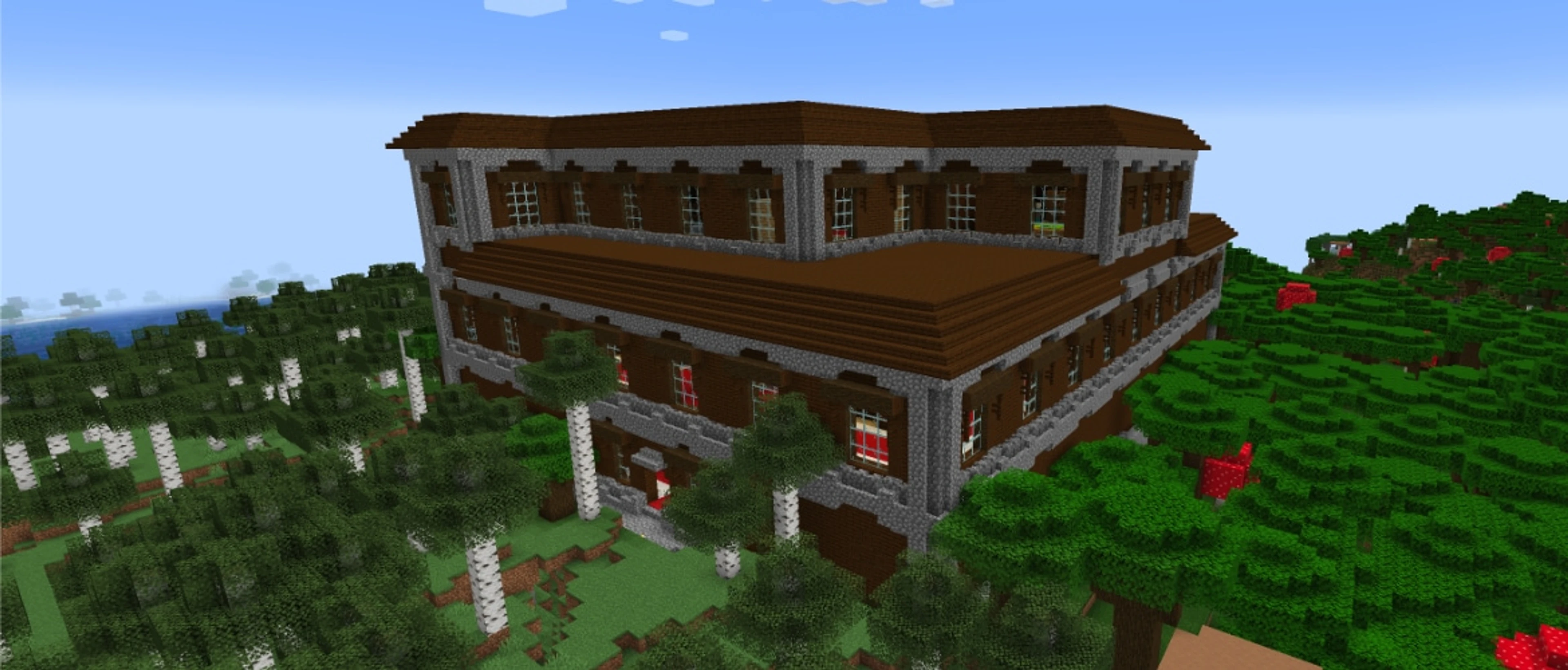 A Minecraft Woodland Mansion standing above the trees in a dark forest biome.