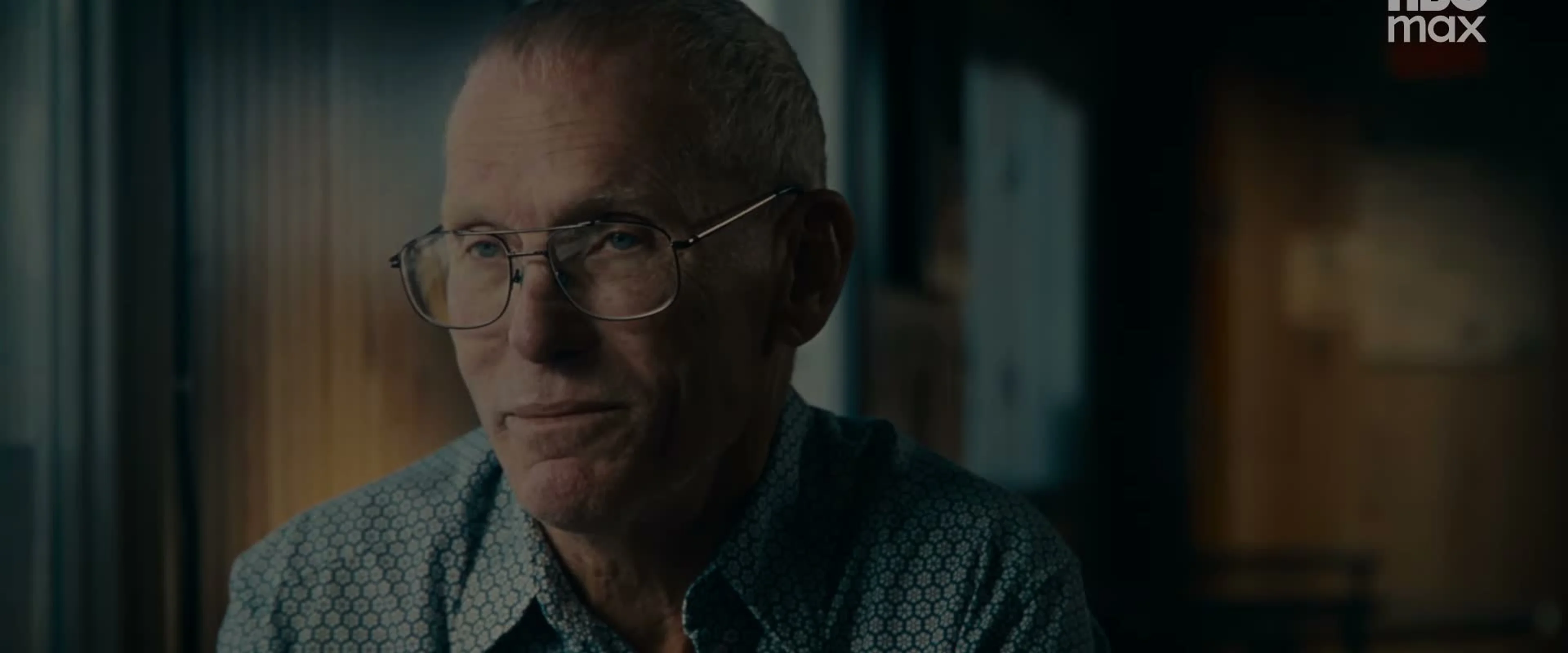 A man wearing glasses sits for an interview in the documentary.