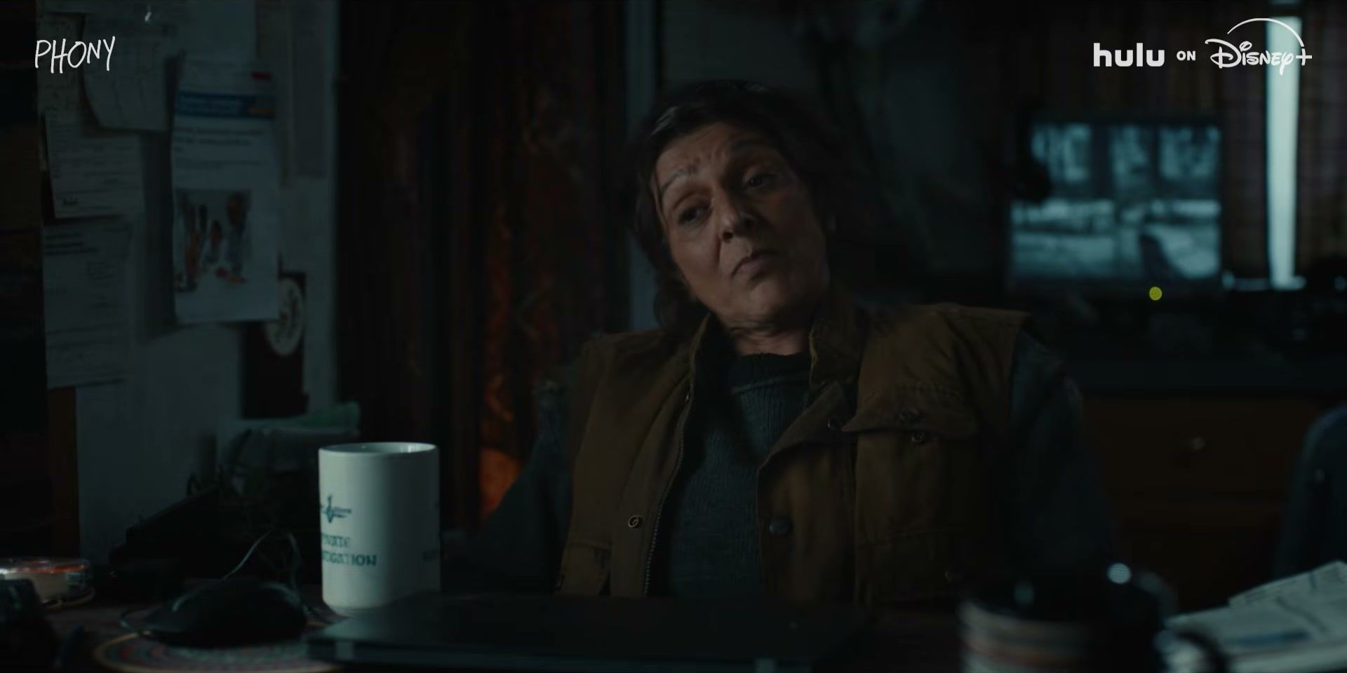 An older woman sits in an office in the Phony trailer.