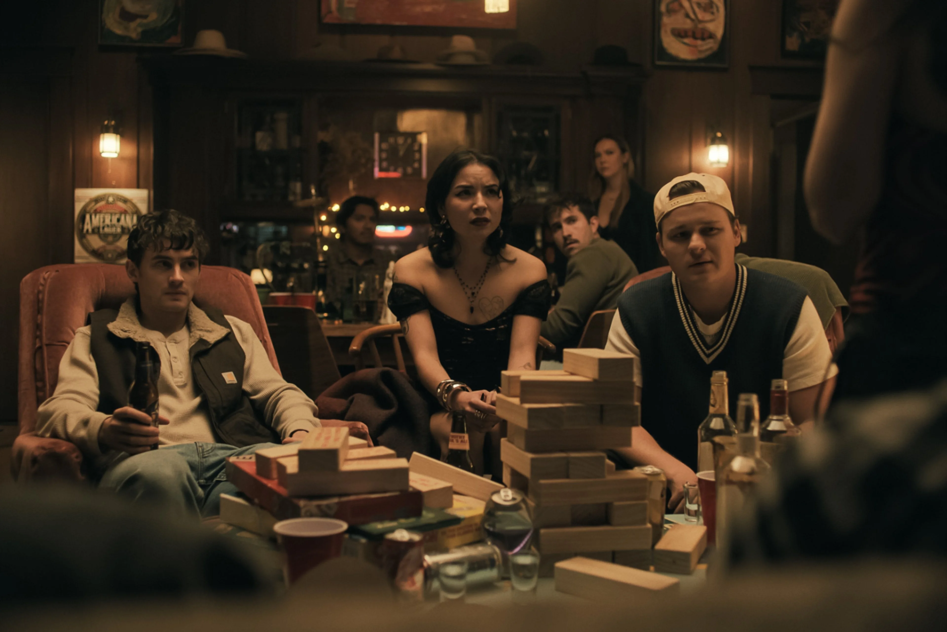 Michael Johnston, Megan Lawless and Cooper Tomlinson sit together in a scene from Obsession.