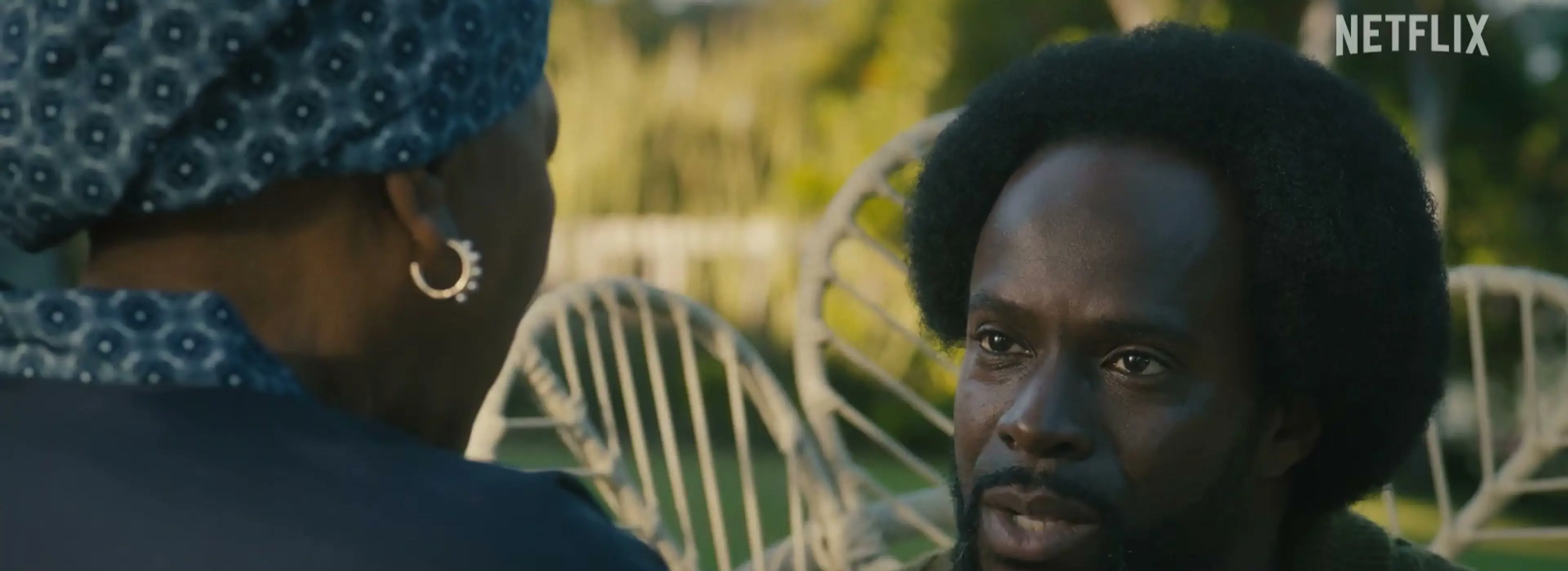 A man speaks with a woman outdoors in Blood Legacy season 2.