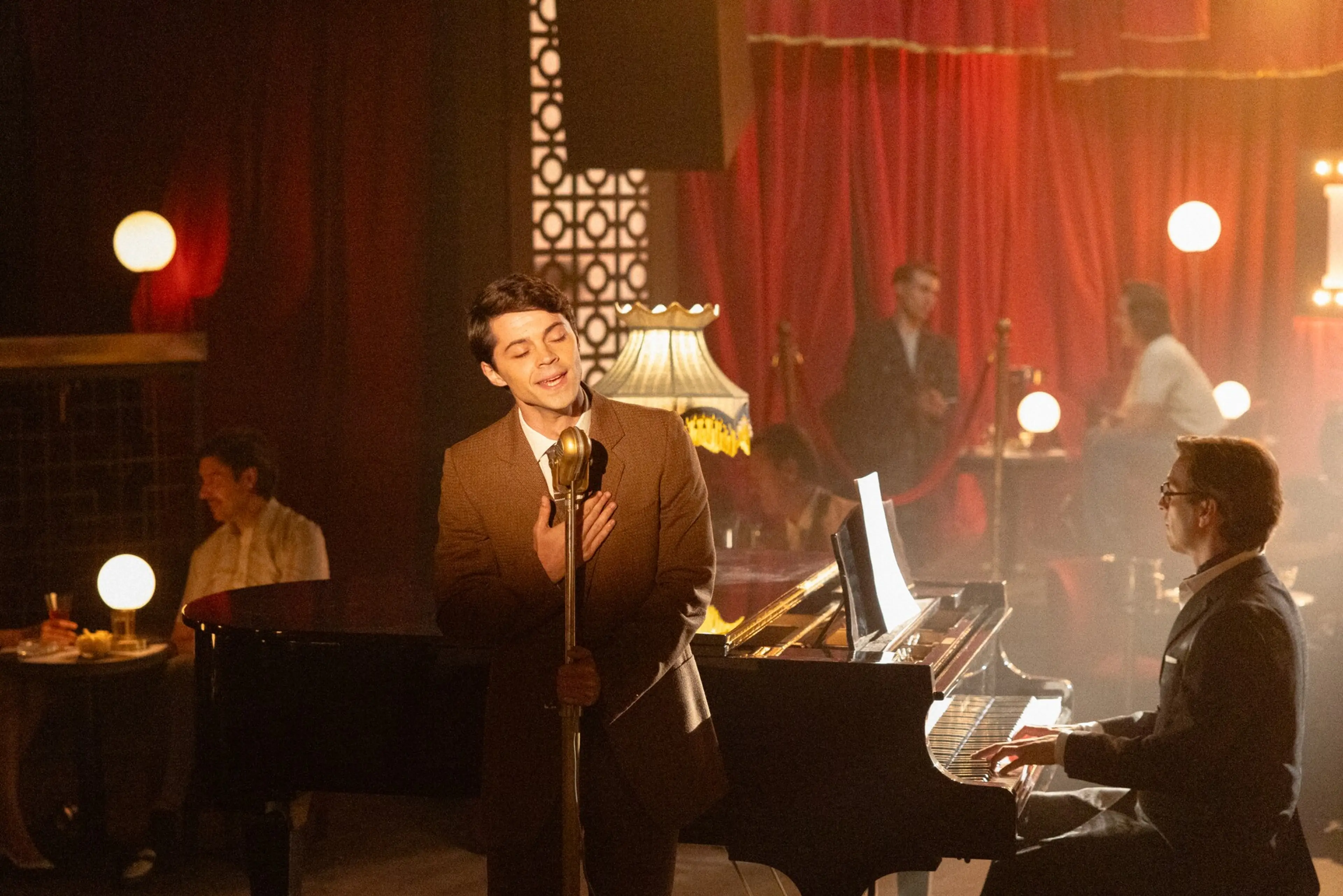 The younger Raphael sings at a microphone beside a pianist in A Day Like No Other.