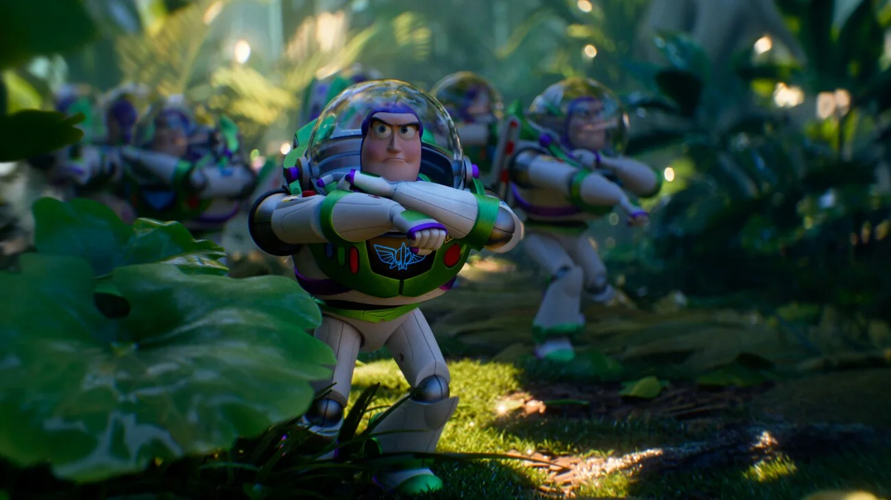 A group of Buzz Lightyear figures moves through a green forest.