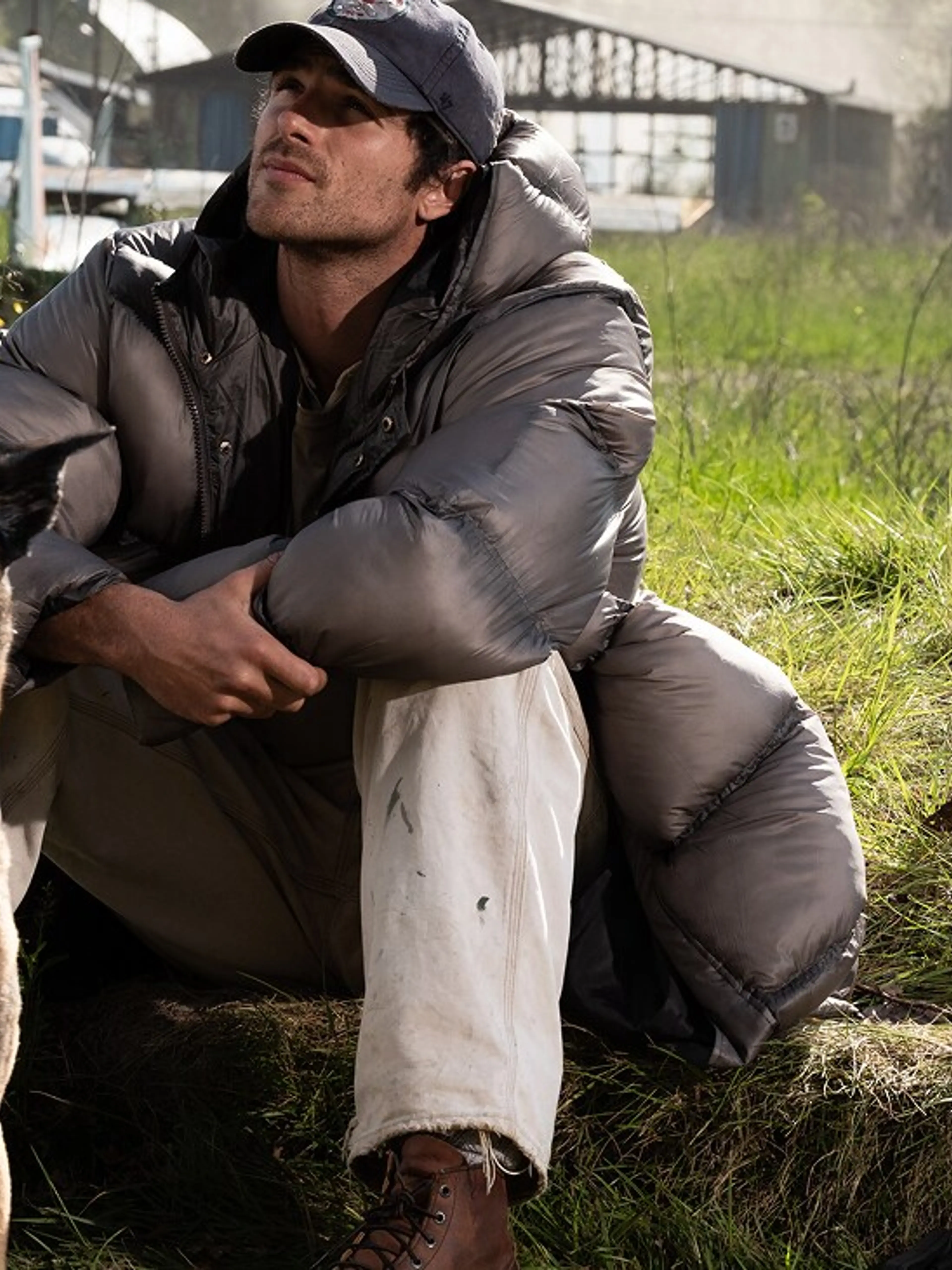Jacob Elordi as Hig sits beside Jasper at an airfield in The Dog Stars.