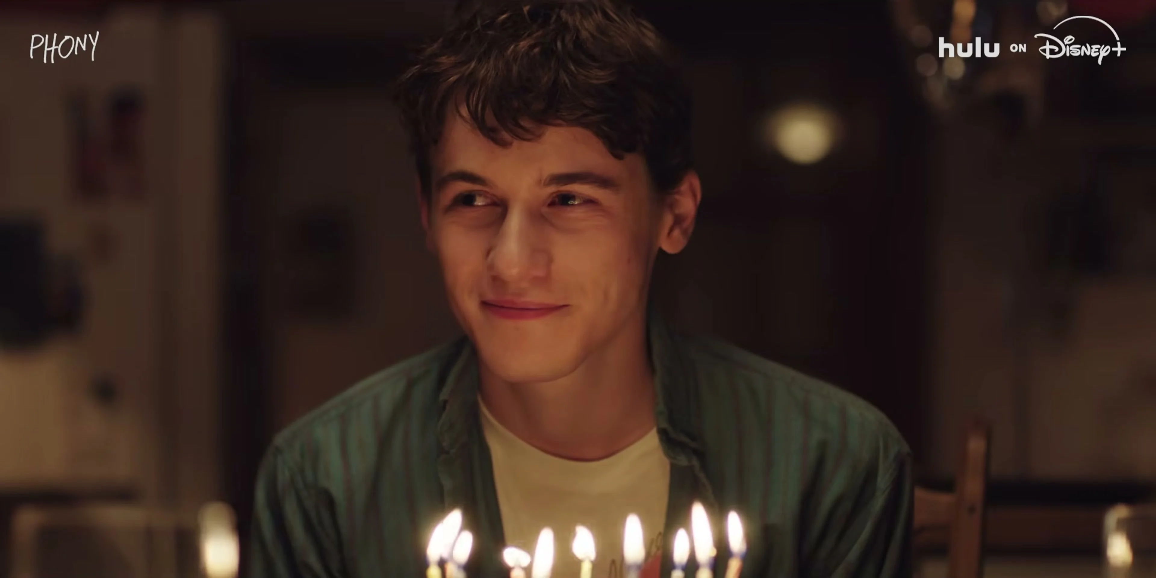 Sam Nivola’s character sits behind birthday candles in the Phony trailer.