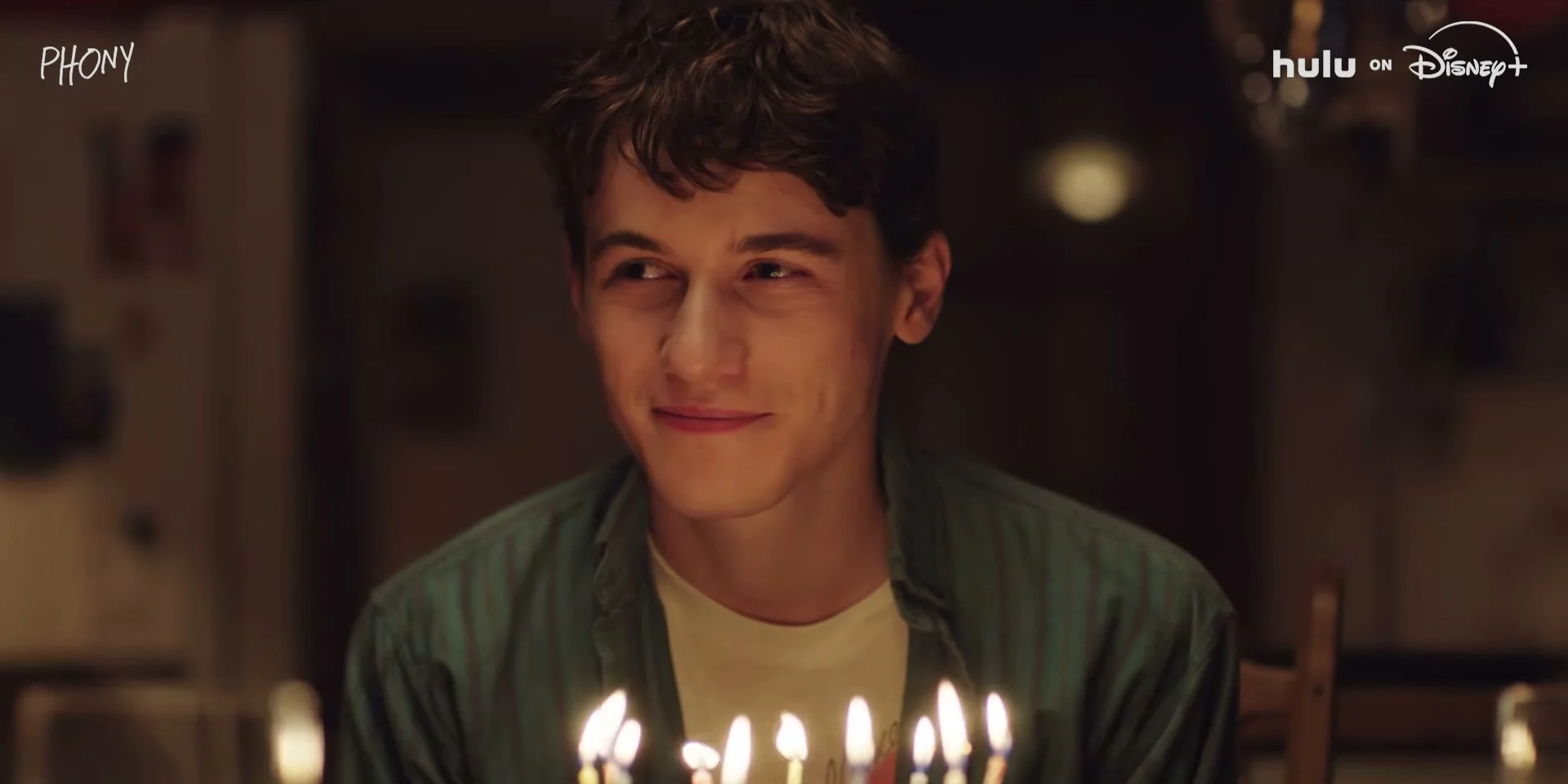 Sam Nivola’s character sits behind birthday candles in the Phony trailer.
