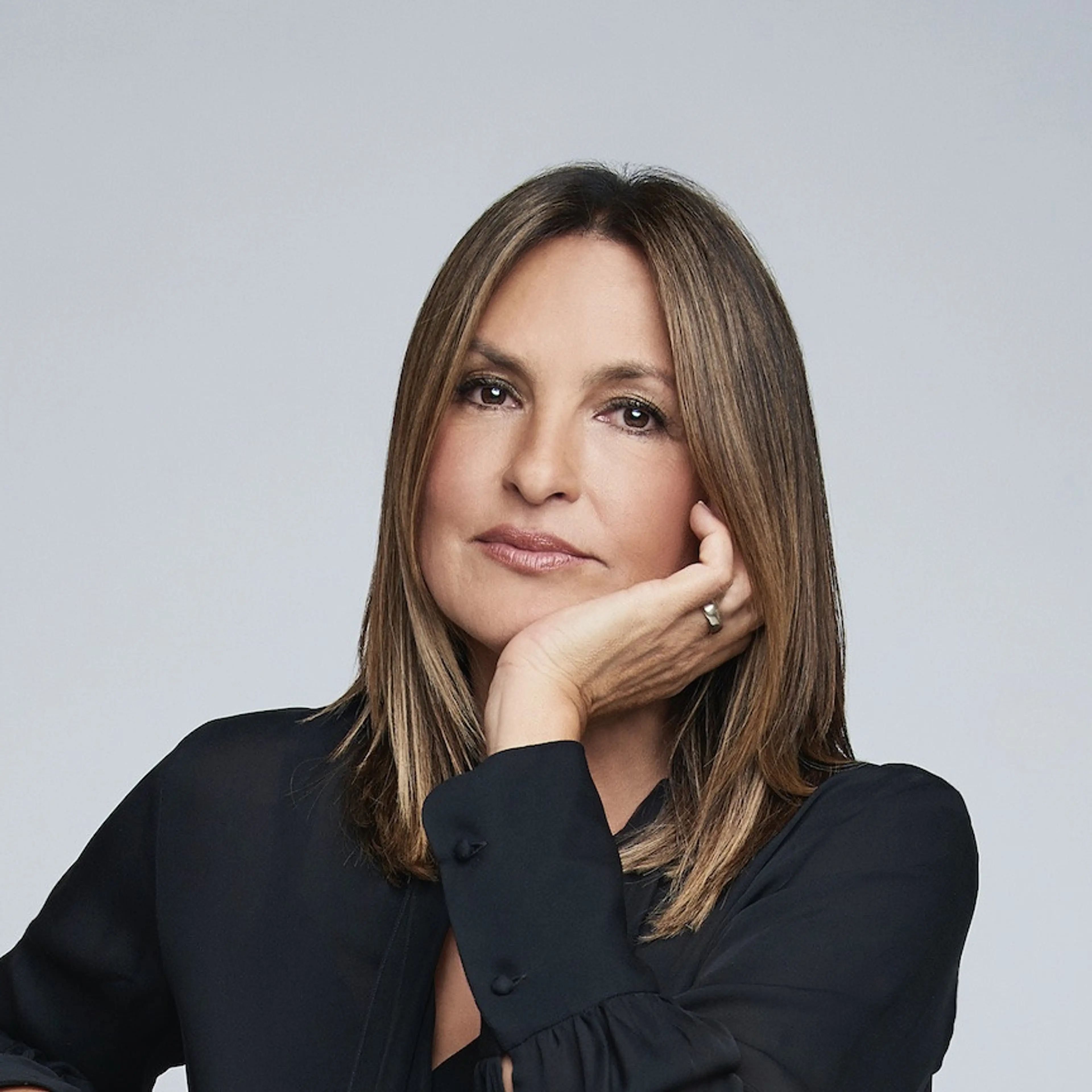 Mariska Hargitay rests her face on her hand in an official portrait by Matt Doyle.