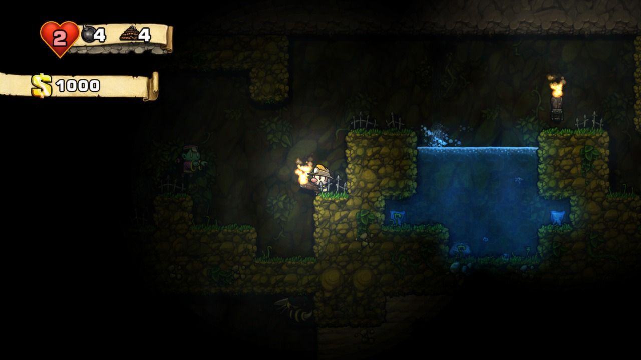 Closer view of a torch-bearing Spelunky explorer beside a blue pool in a mostly dark cave.