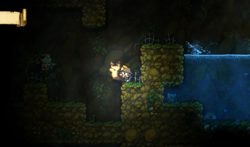 Closer view of a torch-bearing Spelunky explorer beside a blue pool in a mostly dark cave.