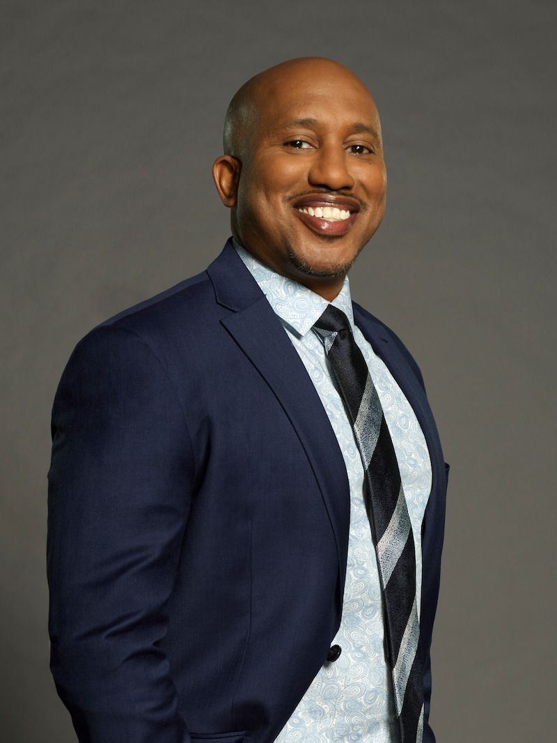 Chris Redd smiles in a blue suit for Celebrity Million Dollar Secret.