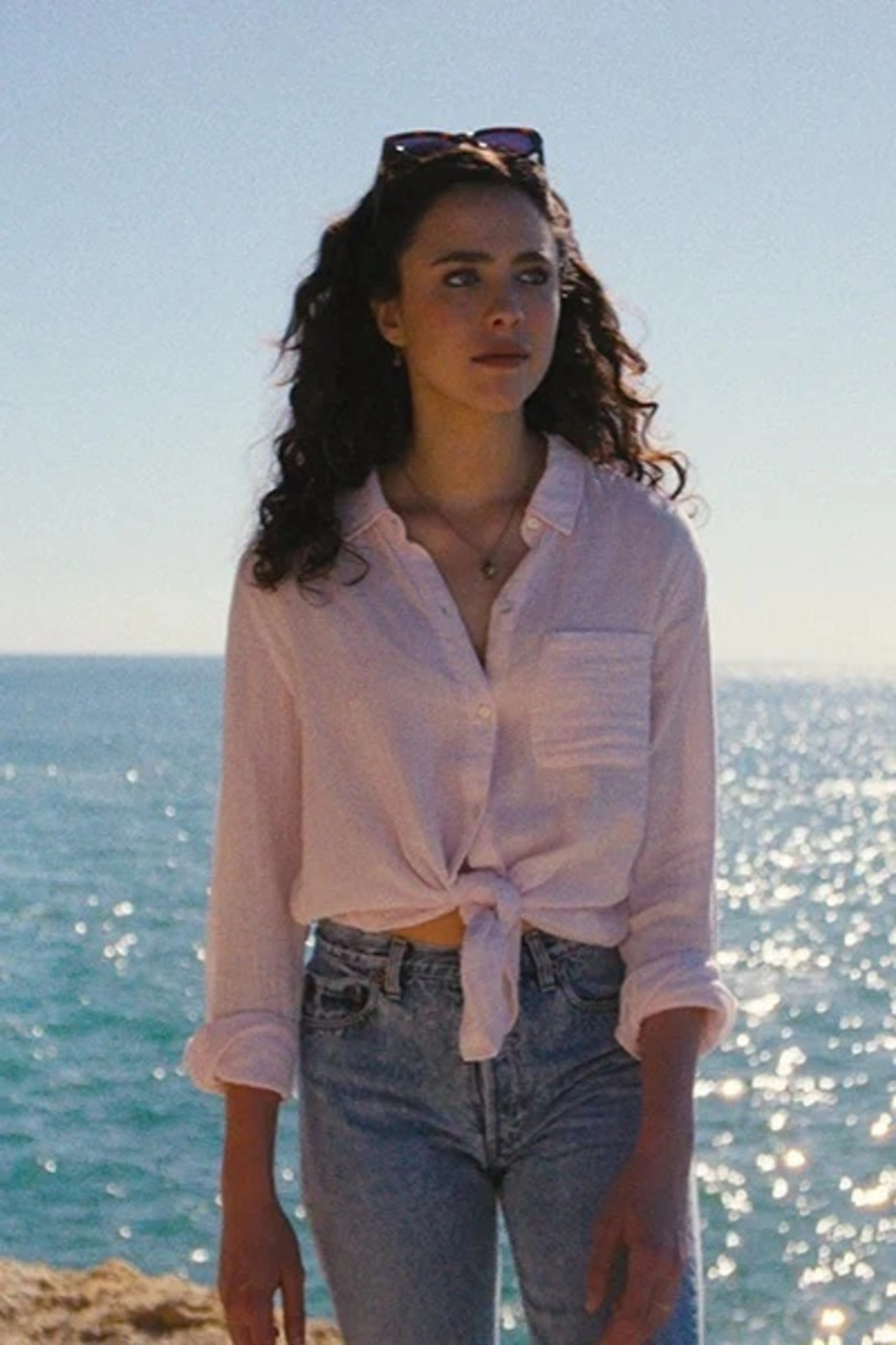 A woman stands beside the sea in an official still from Love of Your Life.