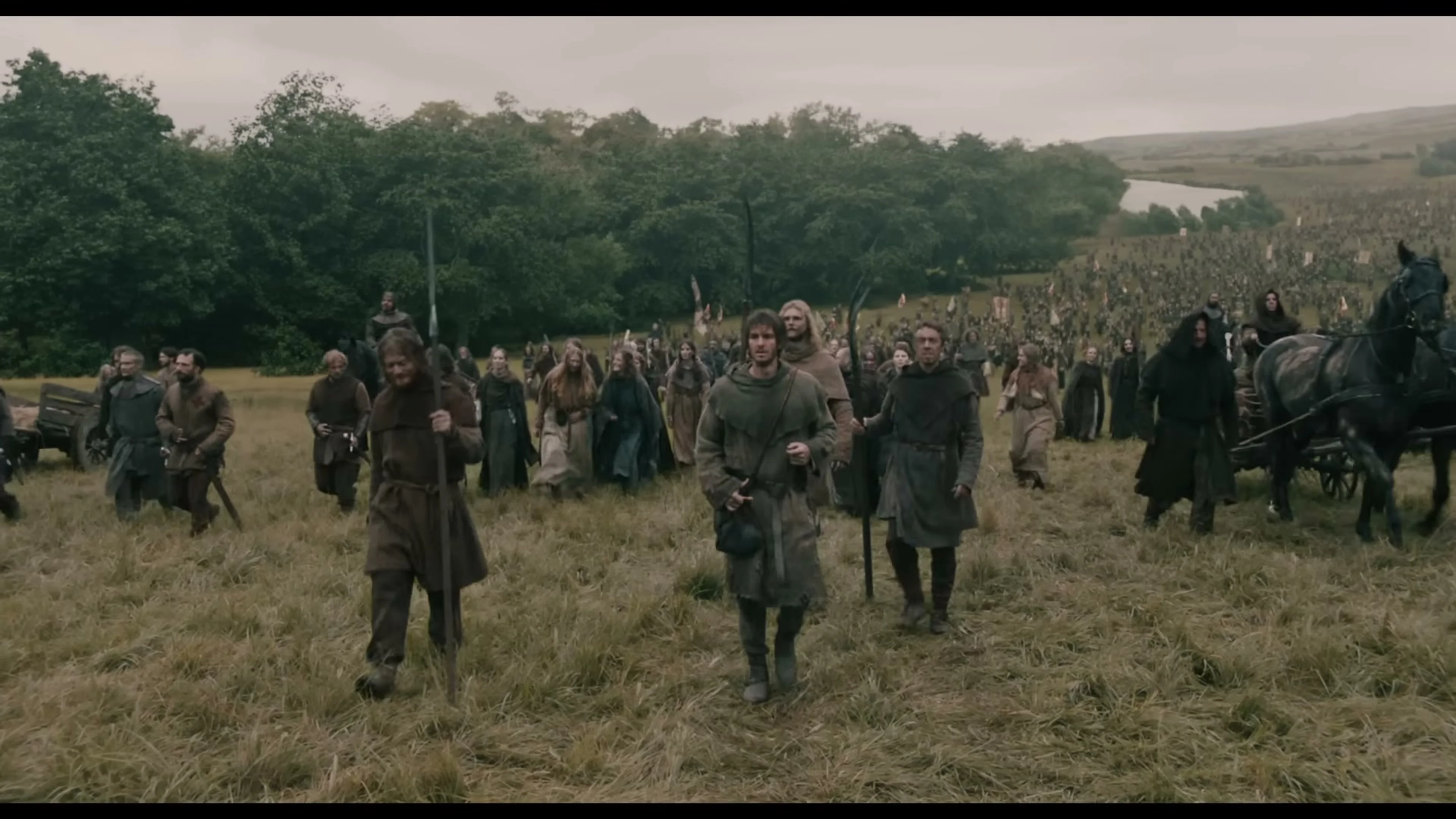 Ploughman walks at the front of a mass rebel march in The Uprising.