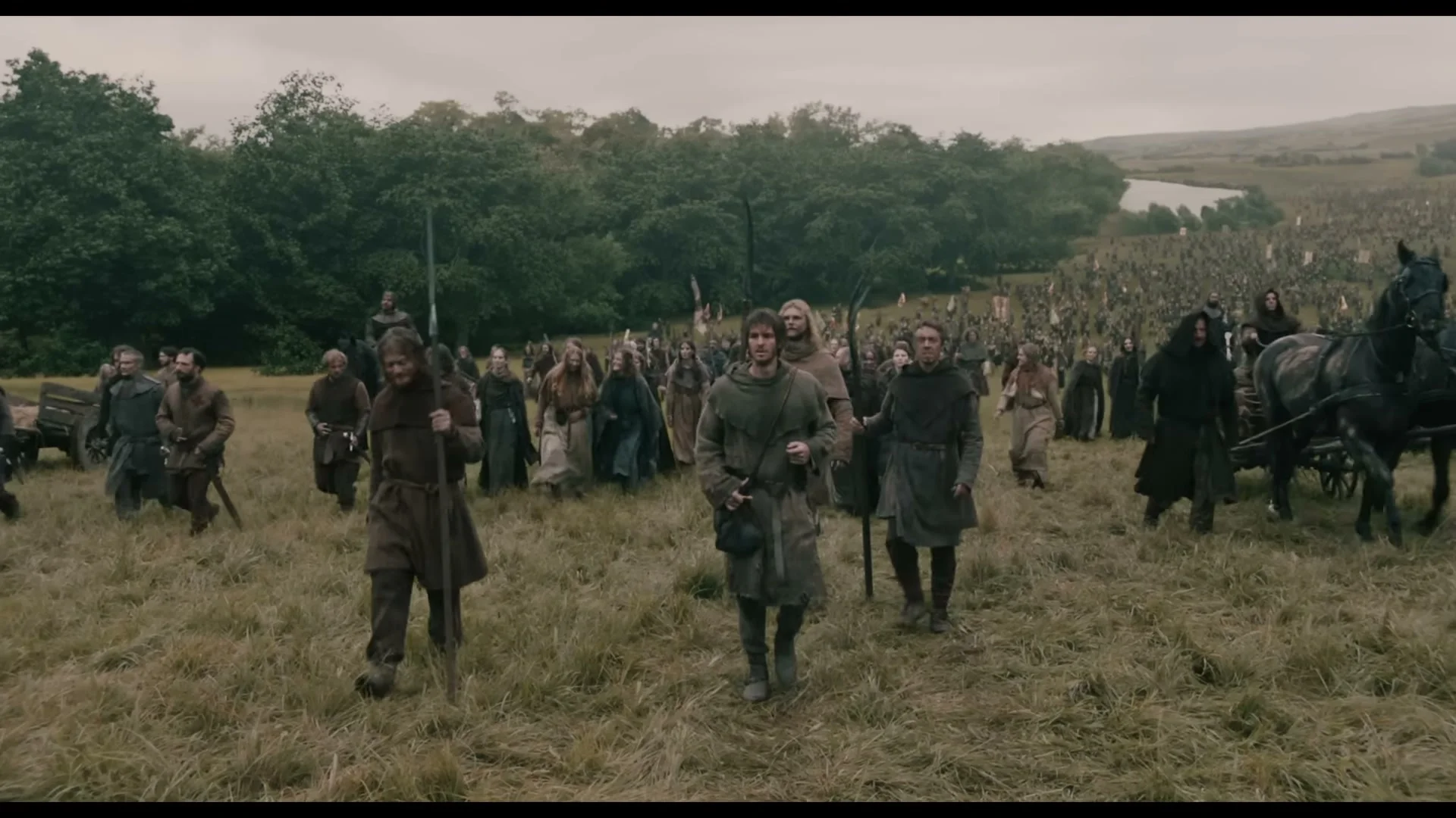 Ploughman walks at the front of a mass rebel march in The Uprising.