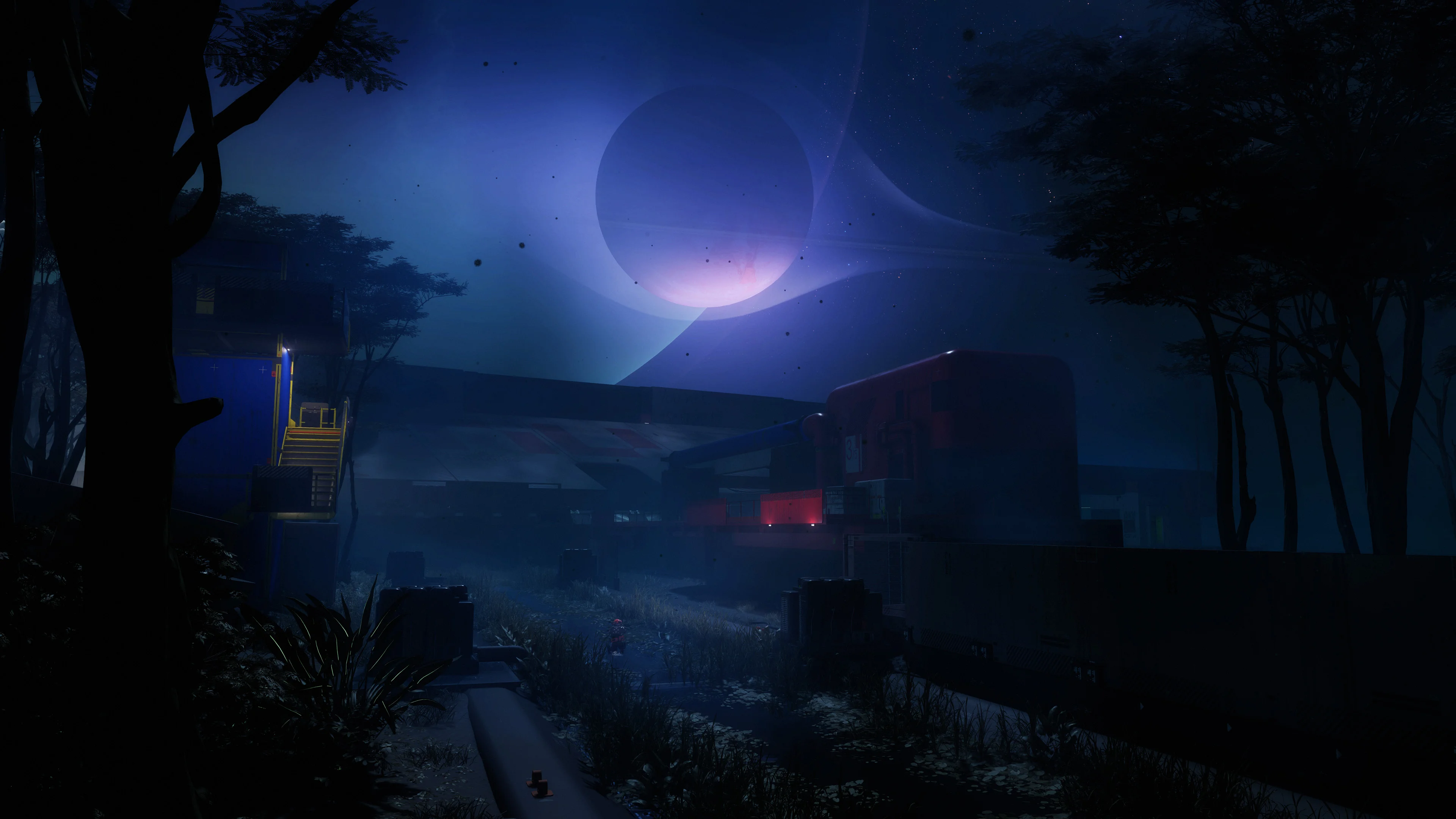 Dark structures and trees sit under a blue sky in Marathon’s Night Marsh.