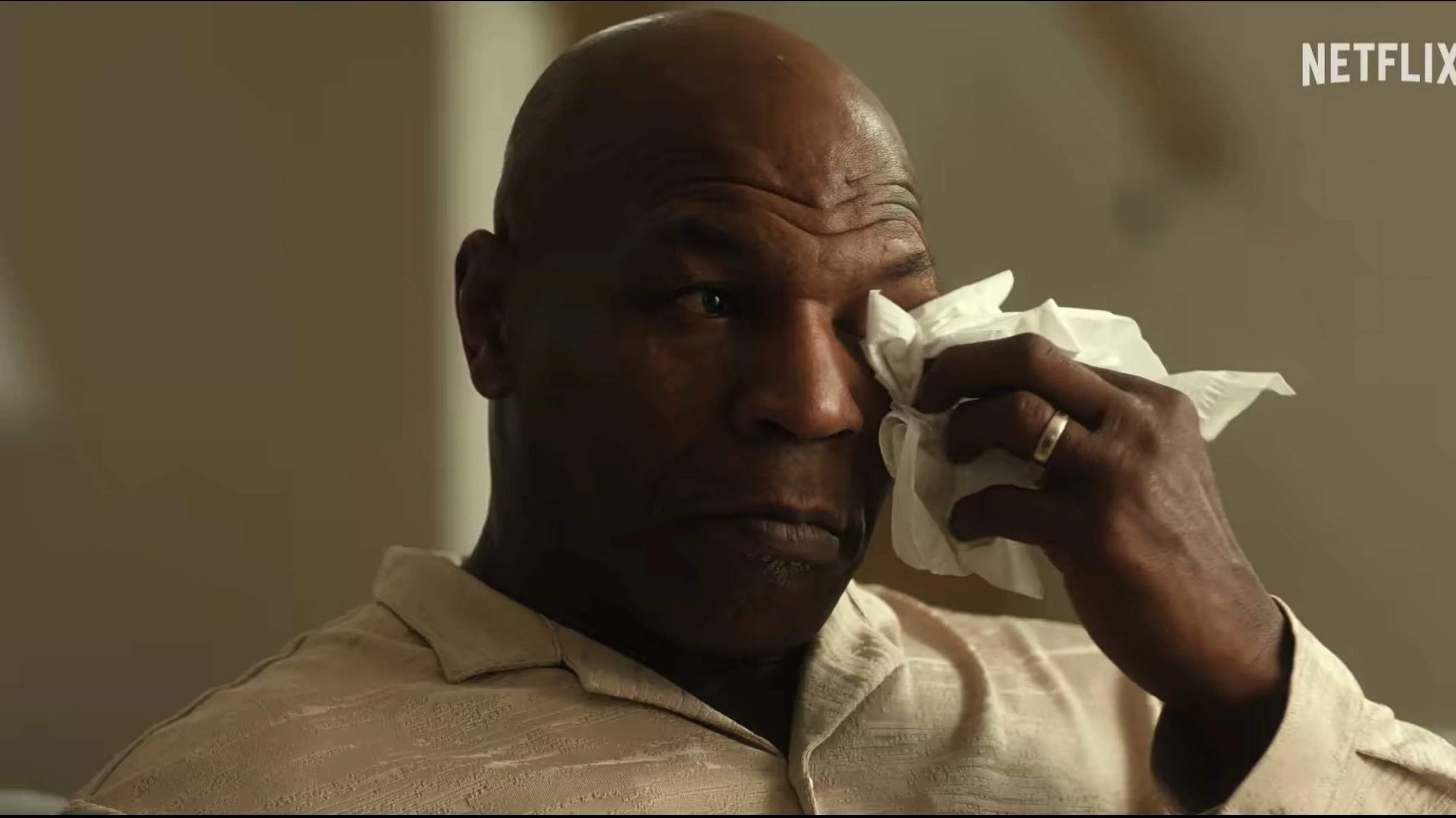 Mike Tyson wipes away tears during an interview.