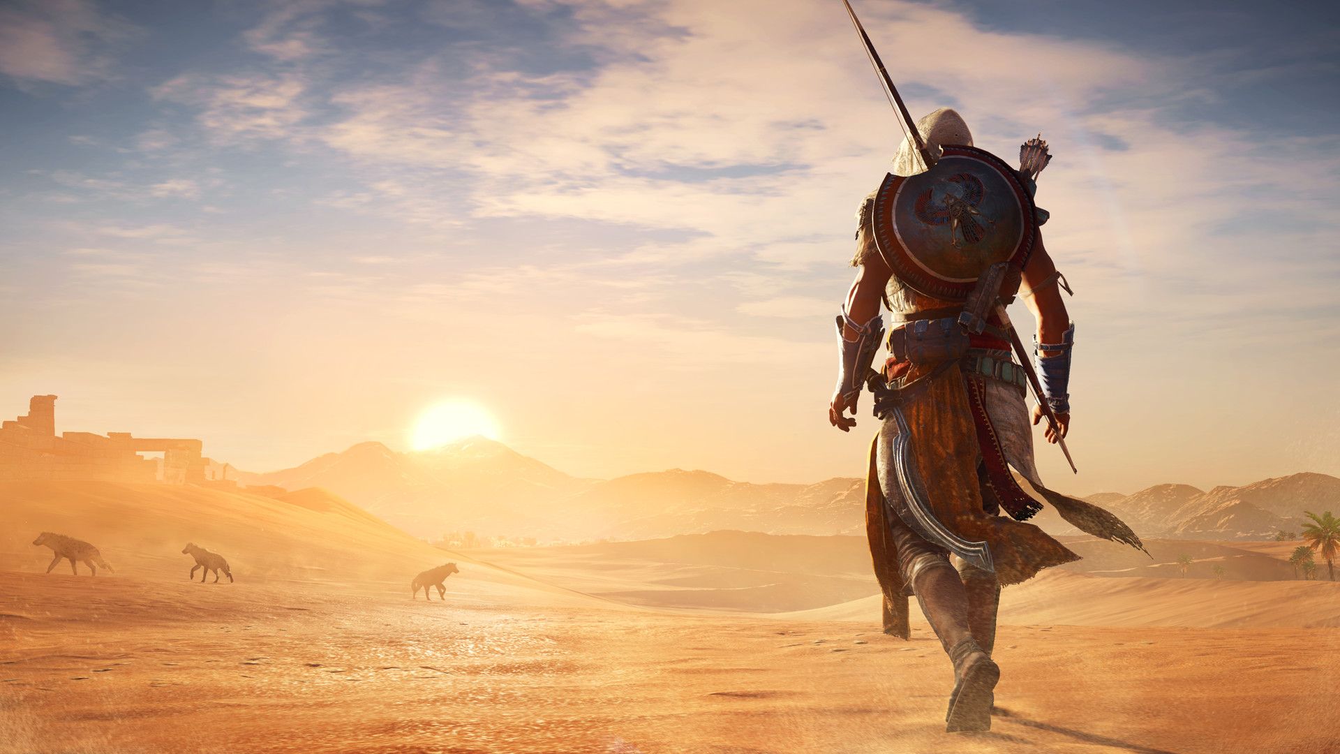 Bayek walks across the Egyptian desert at sunset.