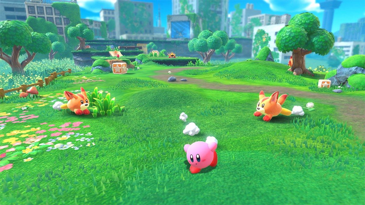 Kirby moves through a green field with small enemies.