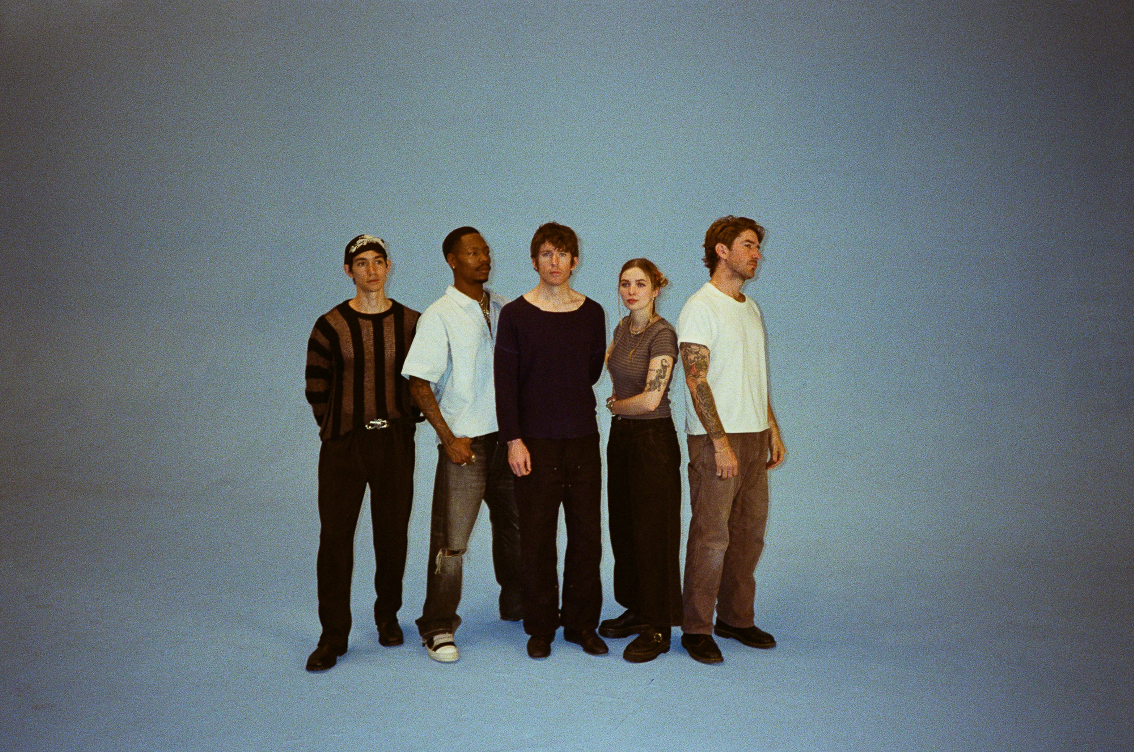 Five Turnstile members stand together in the band’s 2025 official press portrait.