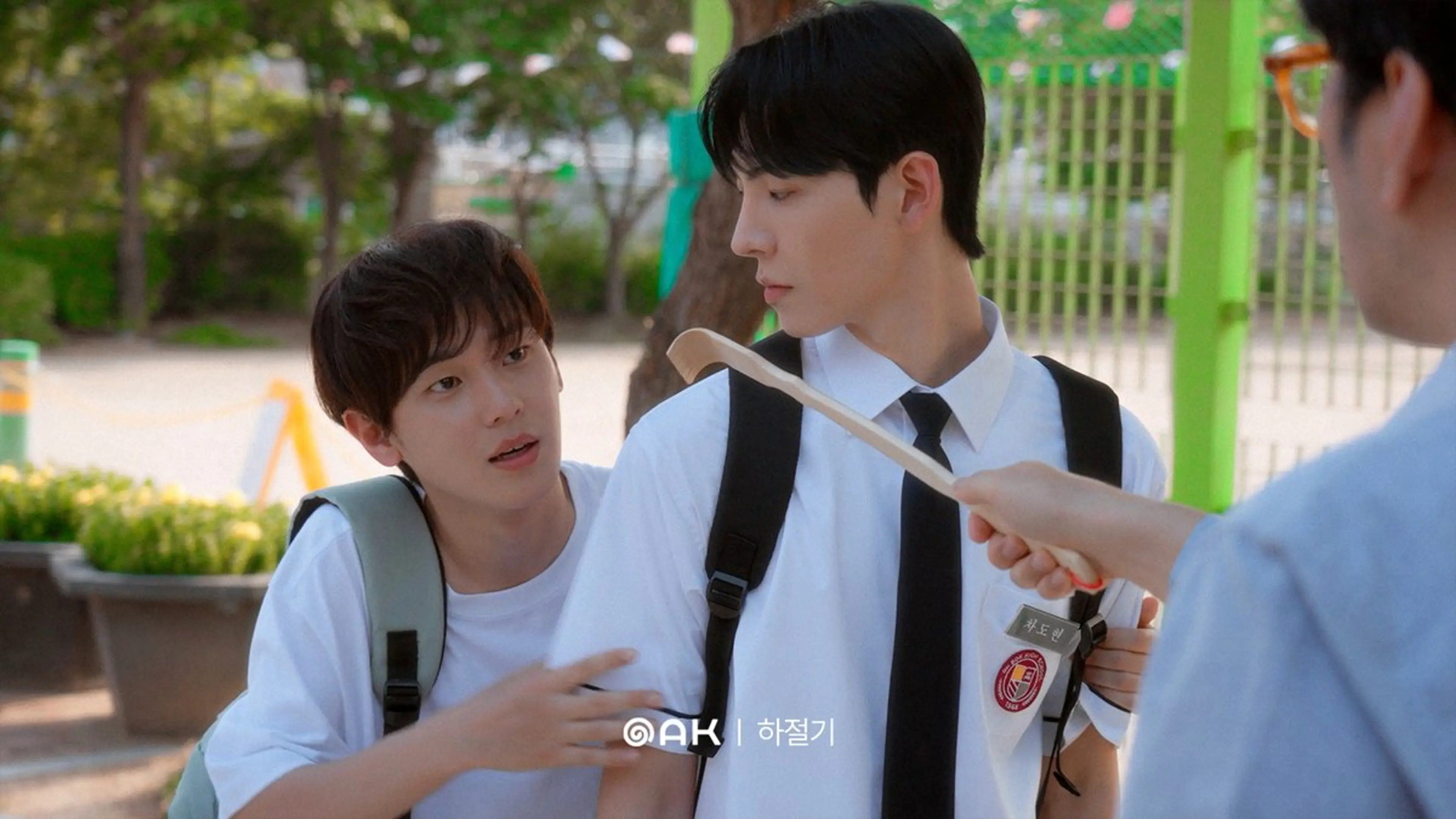 Students share food outside in their school uniforms.