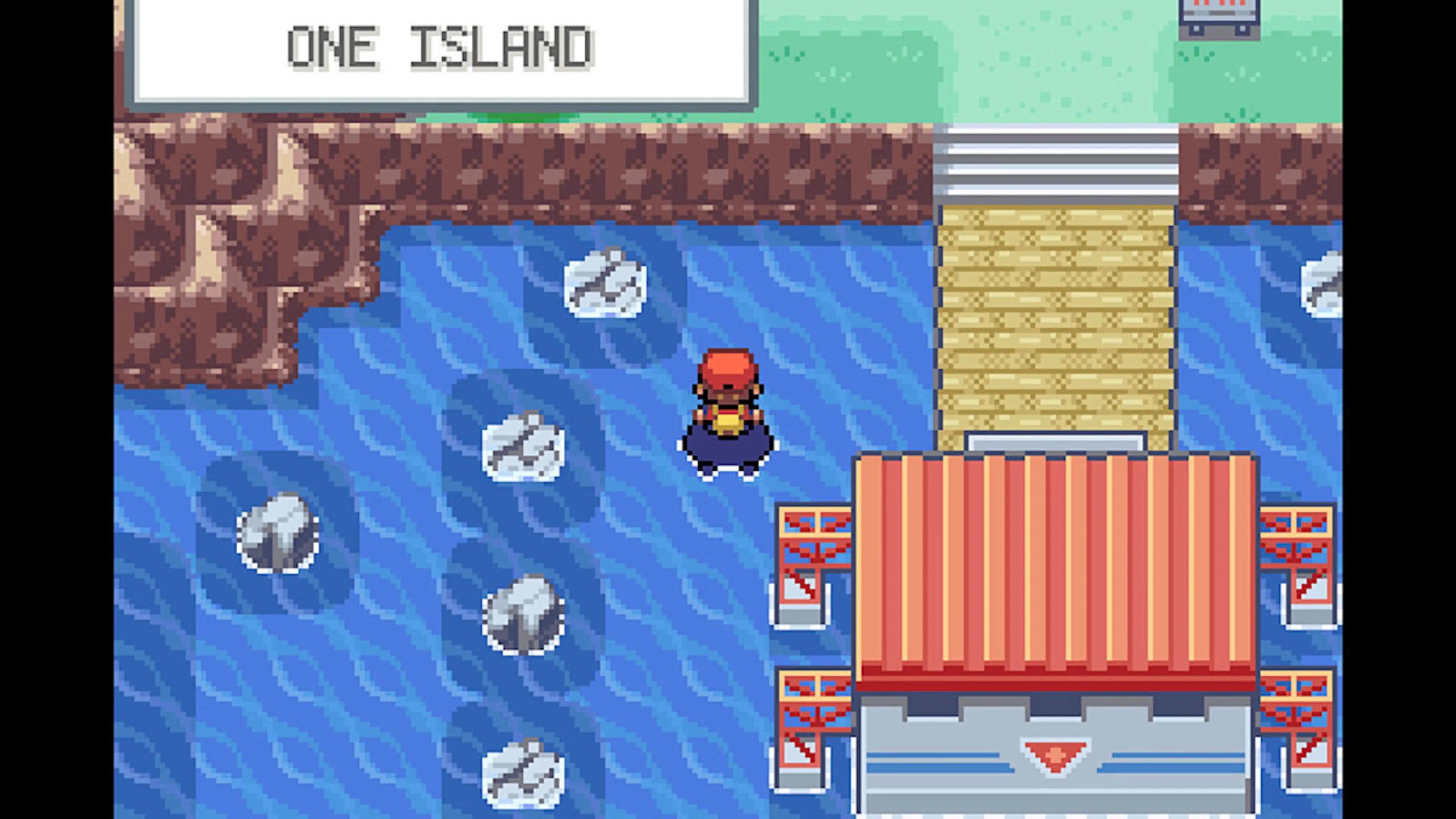 The player character stands by the water outside the Pokémon Center on One Island.