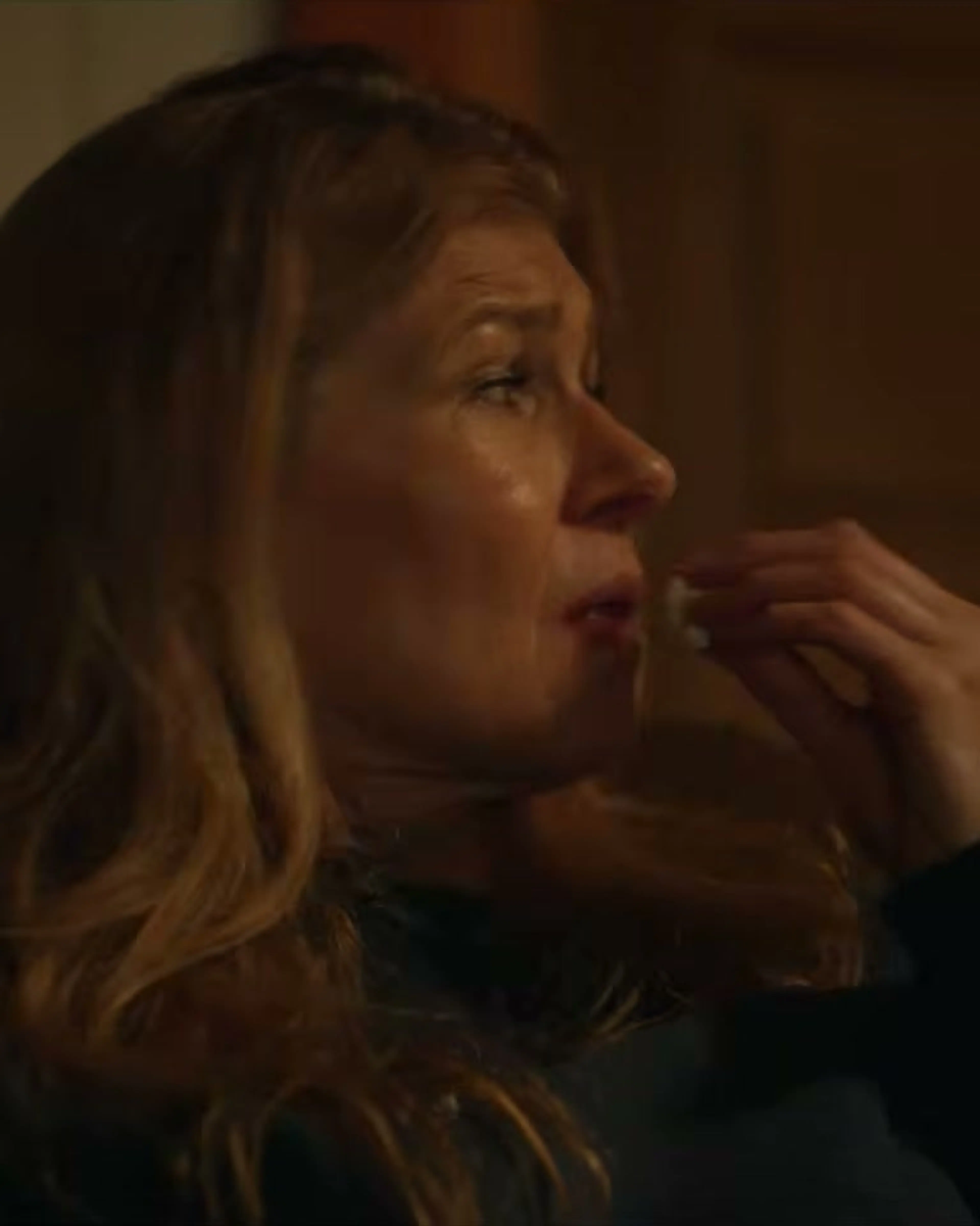 Connie Britton looks across a room in an official Phony trailer frame.