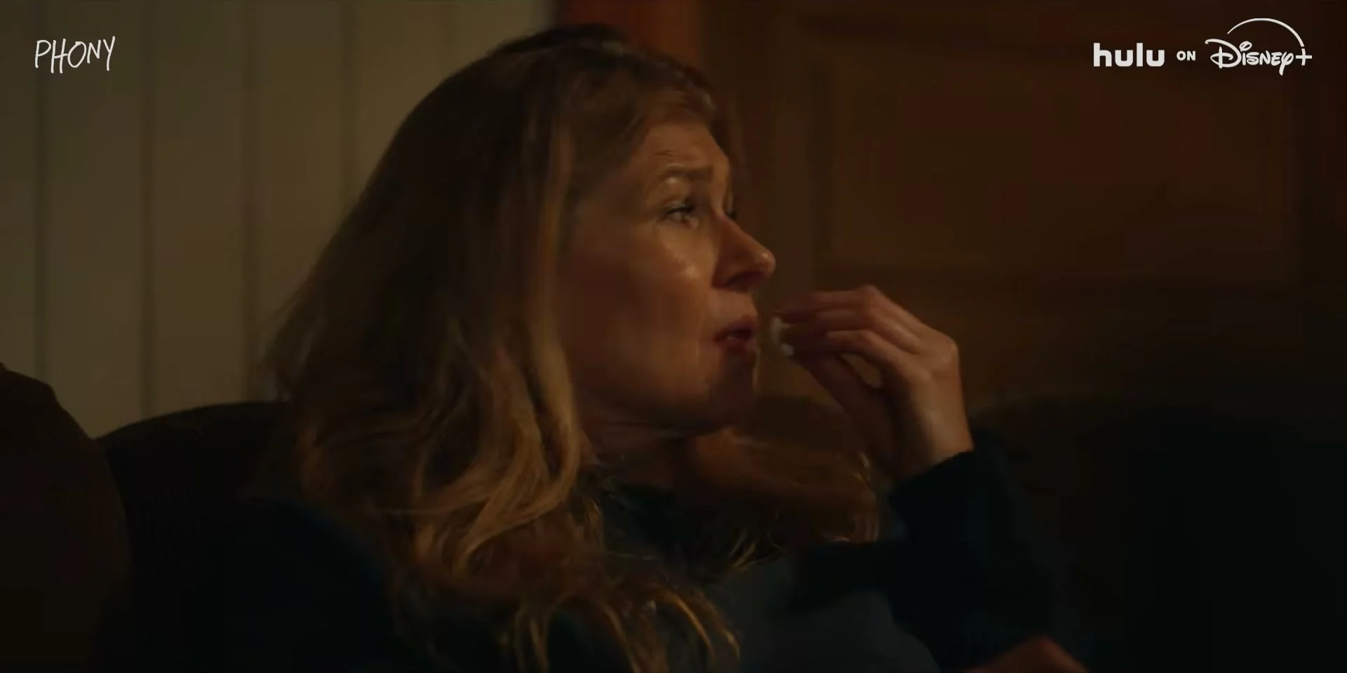 Connie Britton looks across a room in an official Phony trailer frame.