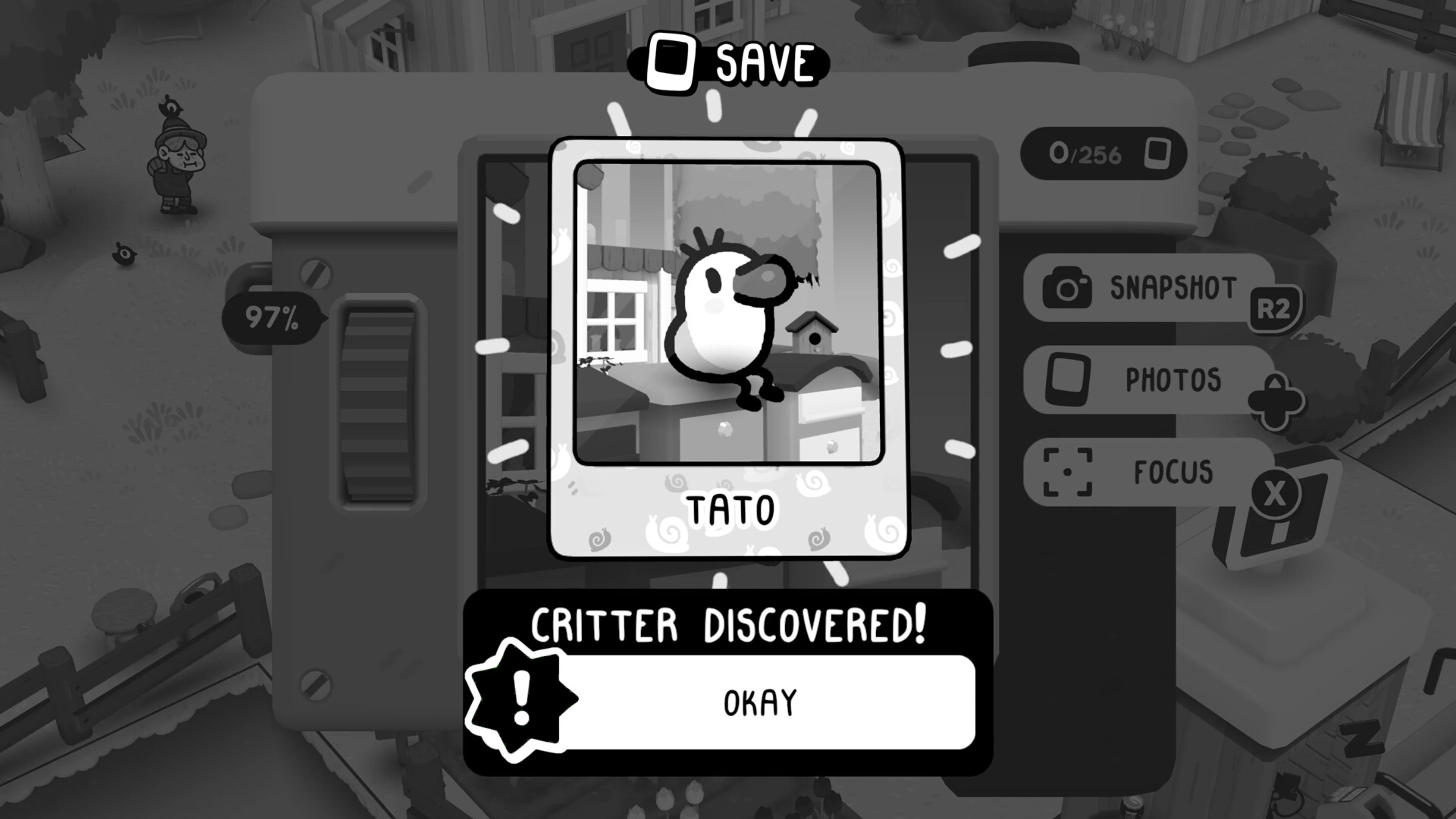 The camera displays a saved photograph of a Tato with a Critter Discovered message.
