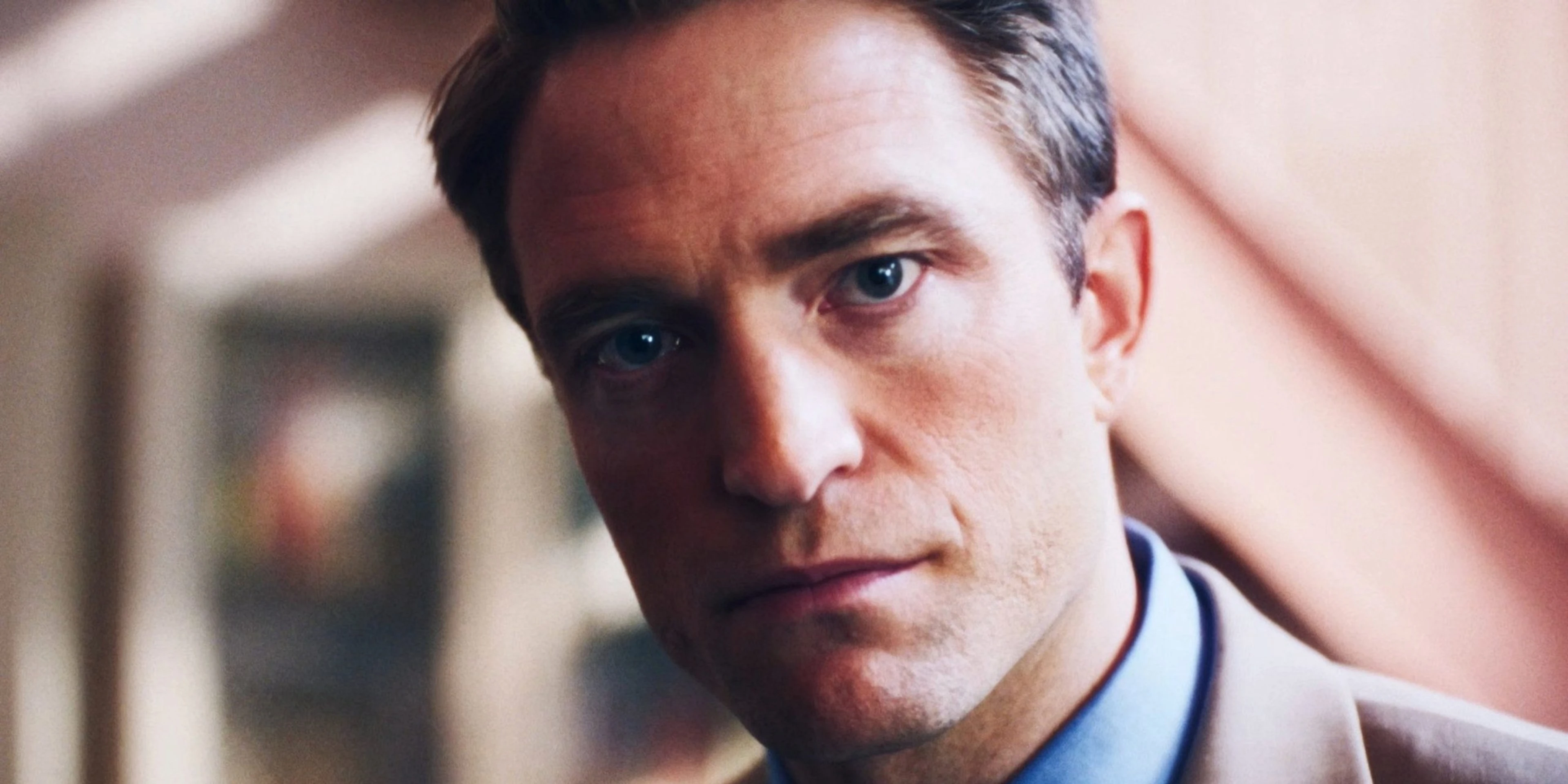Robert Pattinson wears a beige jacket and blue shirt as Chris Hansen in Primetime.